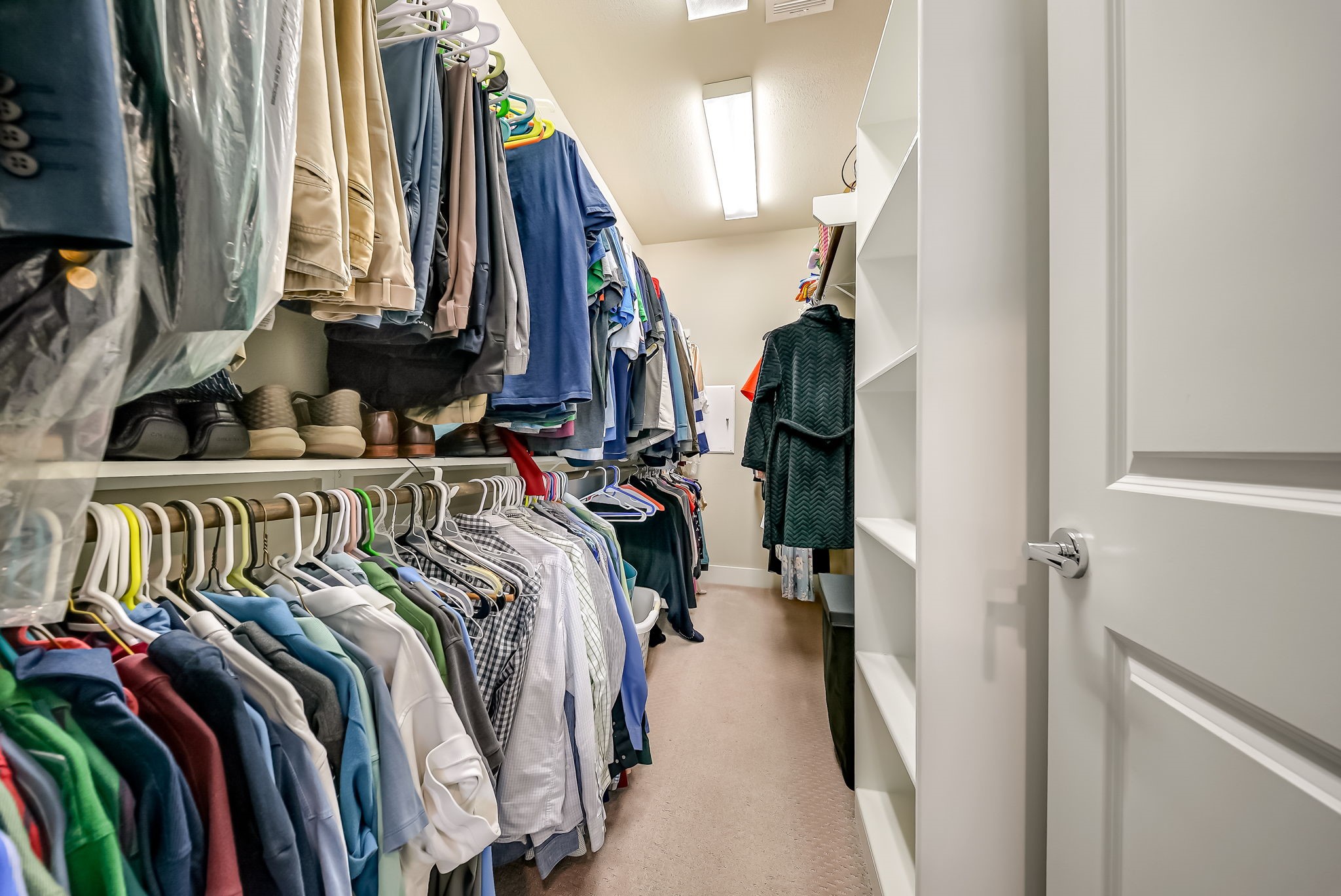 Oversized walk-in closet in the primary suite with extensive storage capacity.