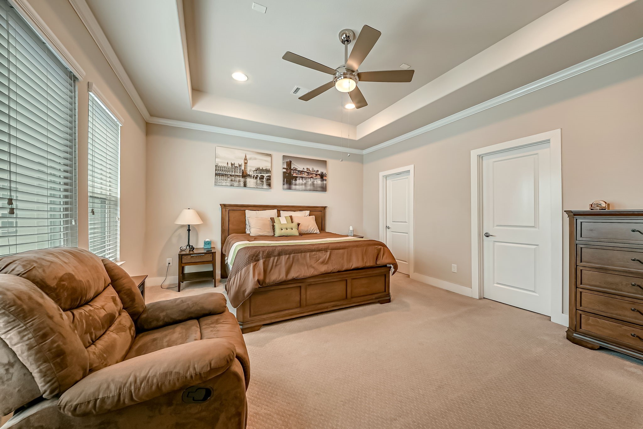 Primary suite sitting area filled with natural light and convenient access to the oversized walk-in closet.