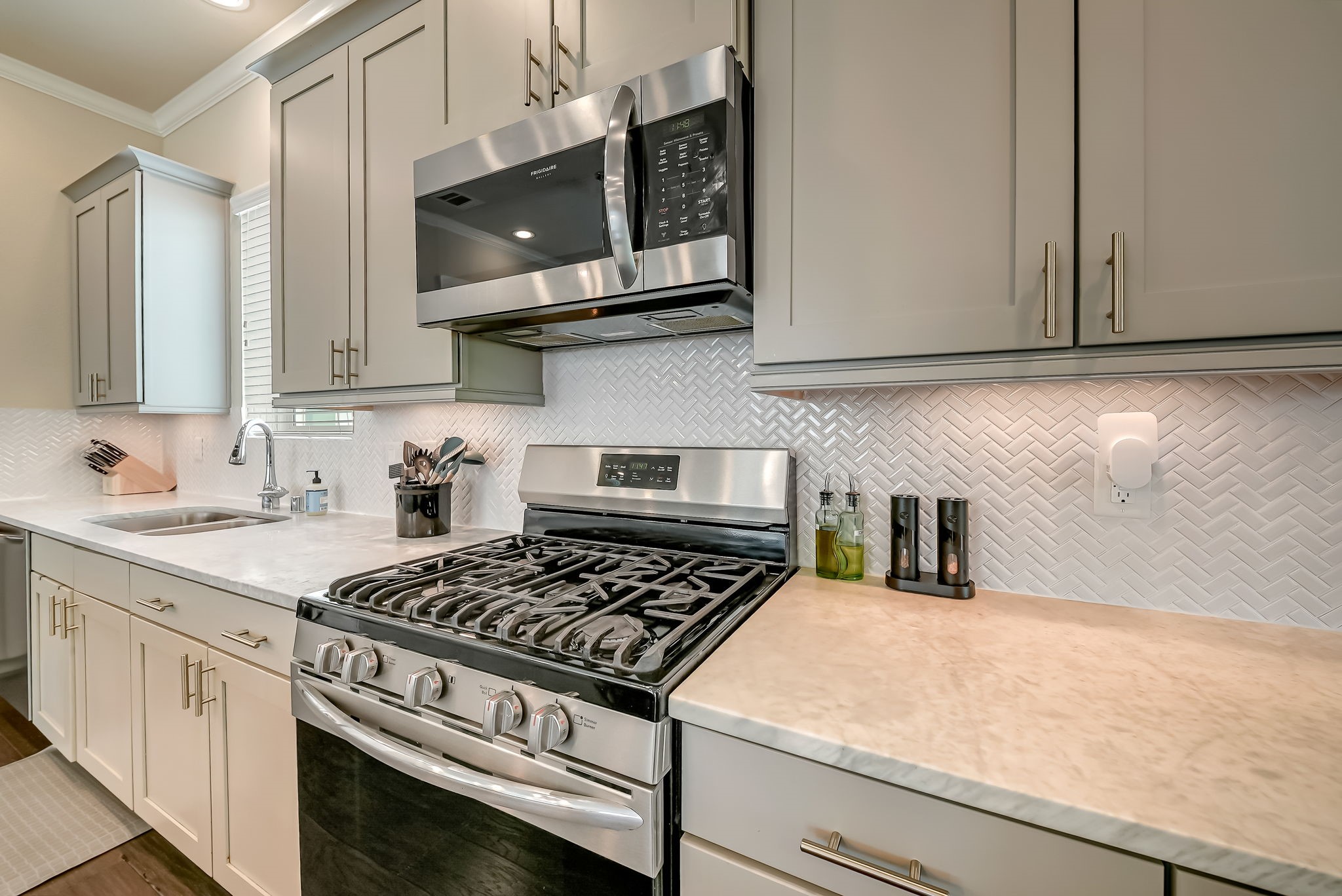 Another view of the well-appointed kitchen highlighting the expansive workspace and modern finishes.