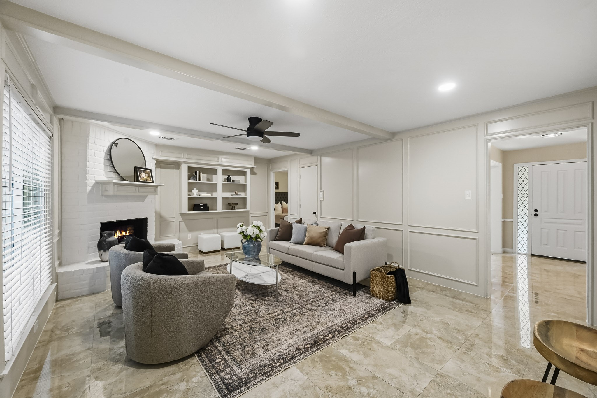 Elegant living room with a cozy fireplace, stylish built-in shelves, and modern dcor, perfect for relaxing or entertaining.