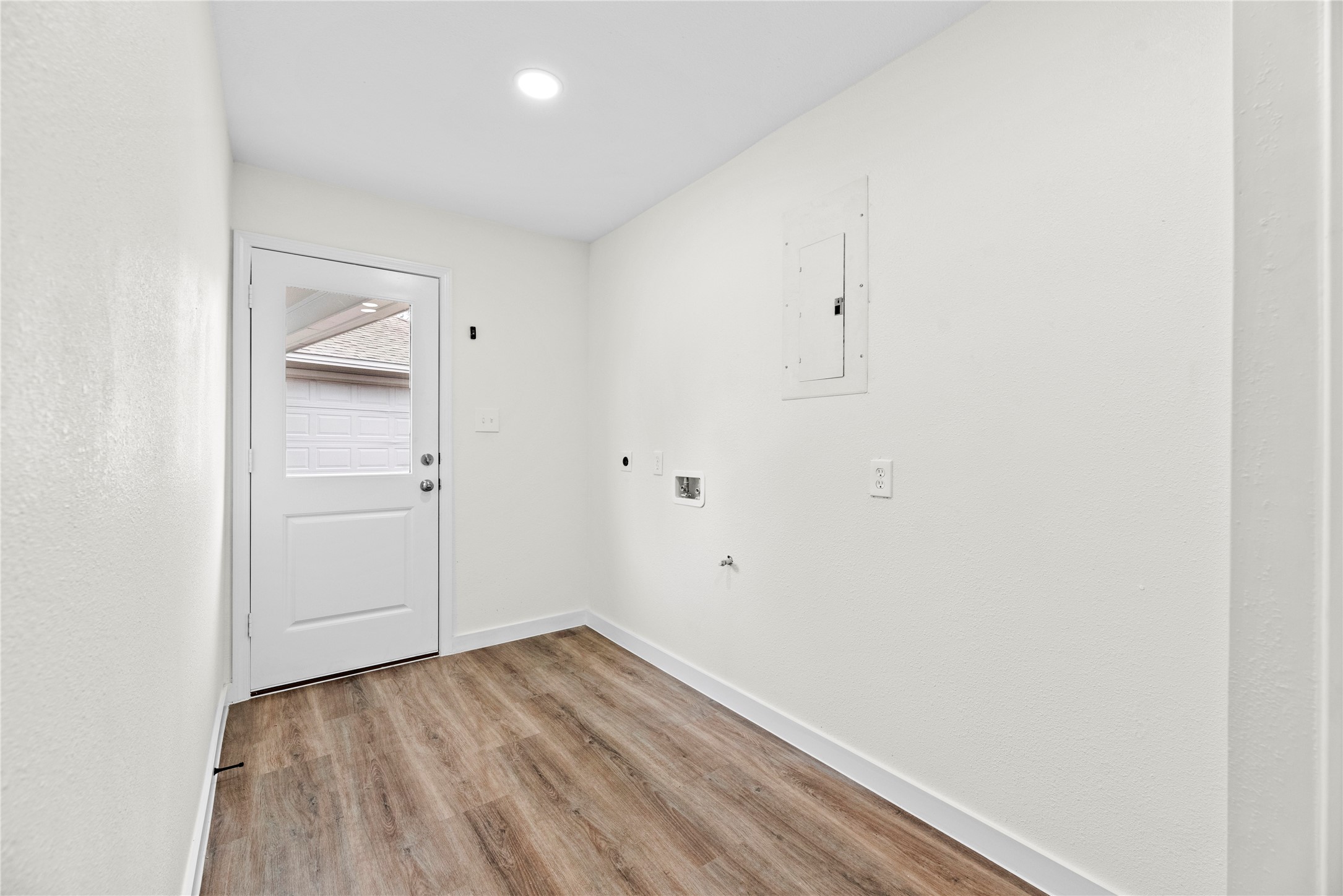 Downstairs utility room with access to the backyard.