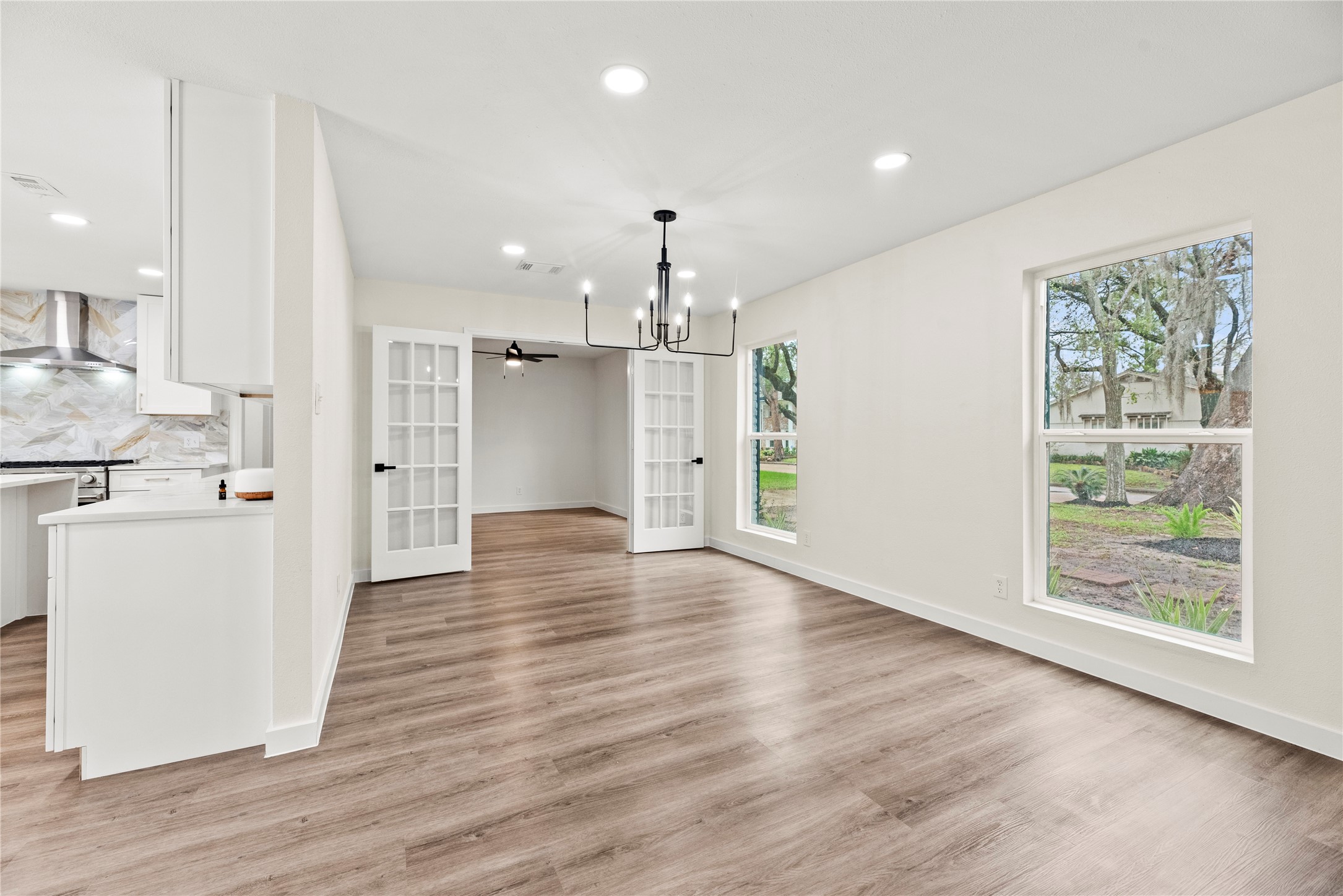 Dining room just off the kitchen. The home office is through the French doors.