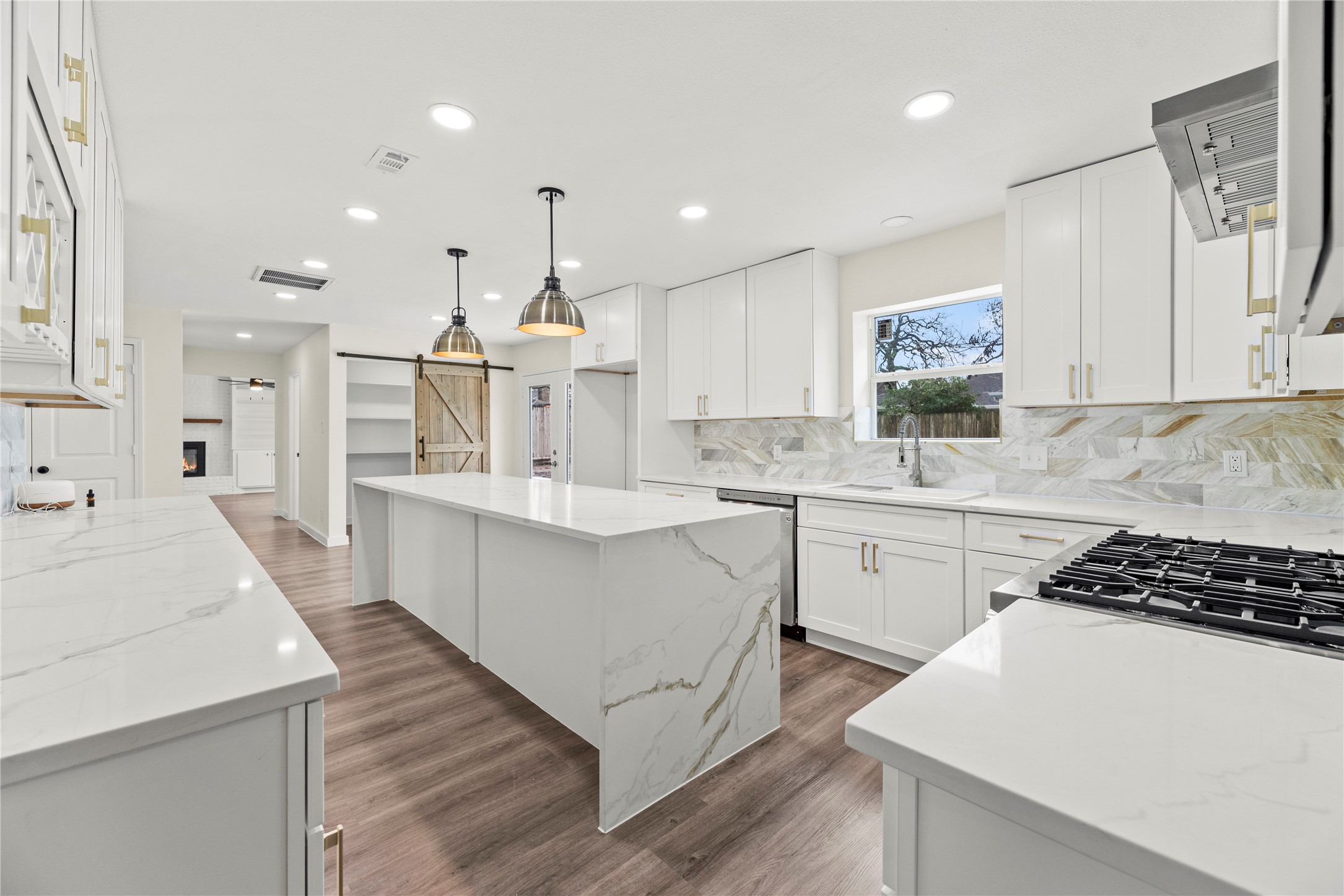 Gorgeous waterfall edge island with pendant lighting.