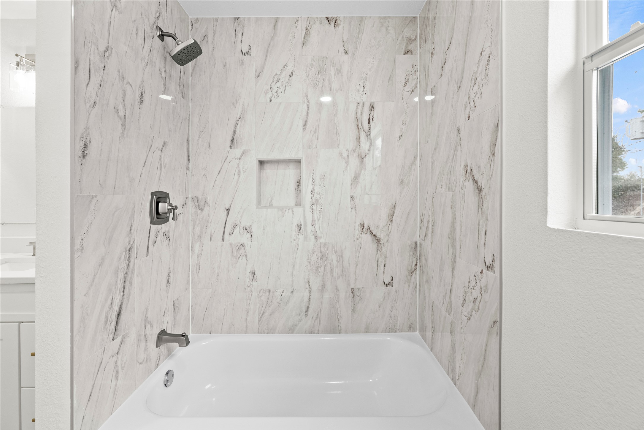 Tub/shower combination in the upstairs secondary bathroom.