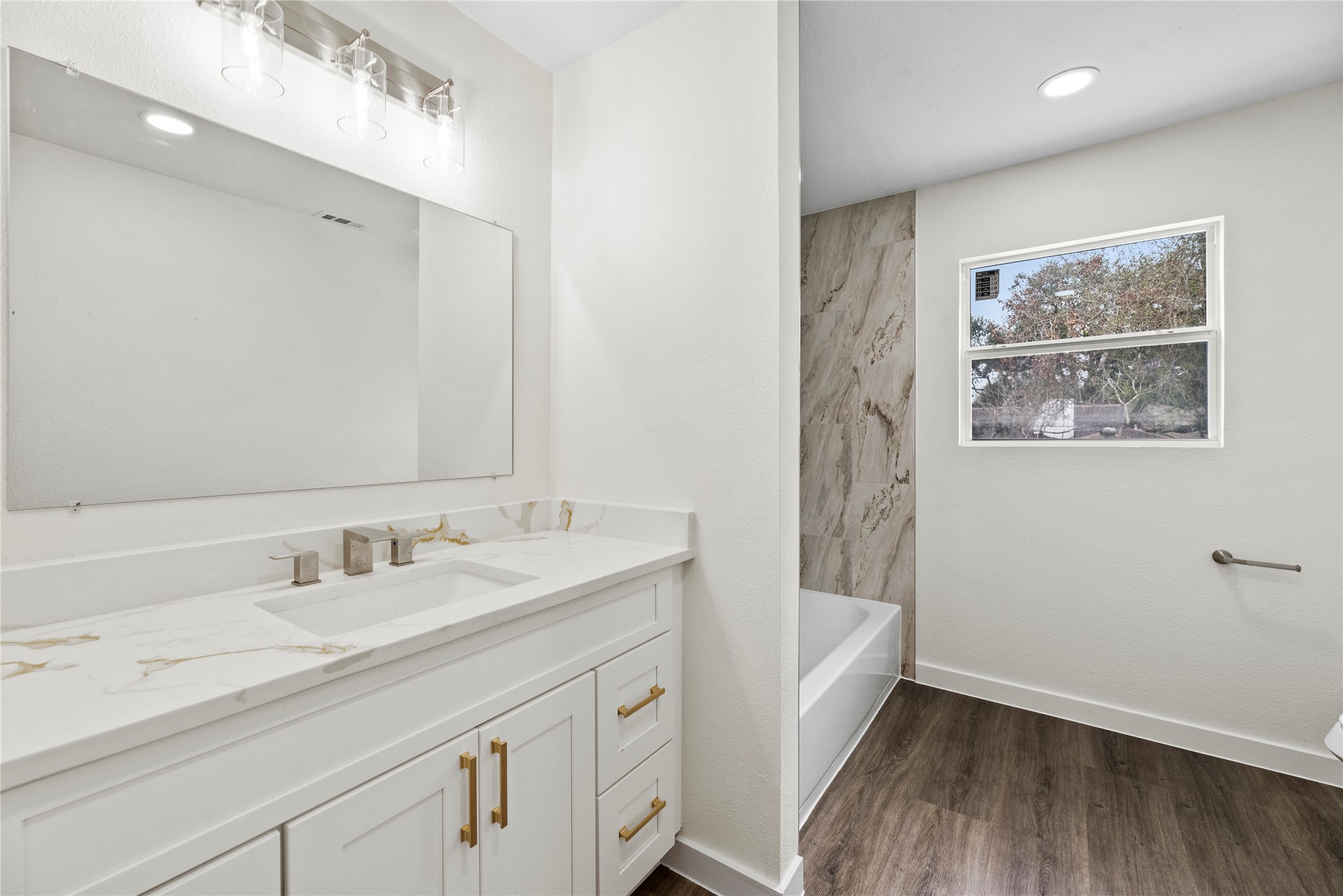 Upstairs full bathroom with a new vanity, hardware and fixtures.