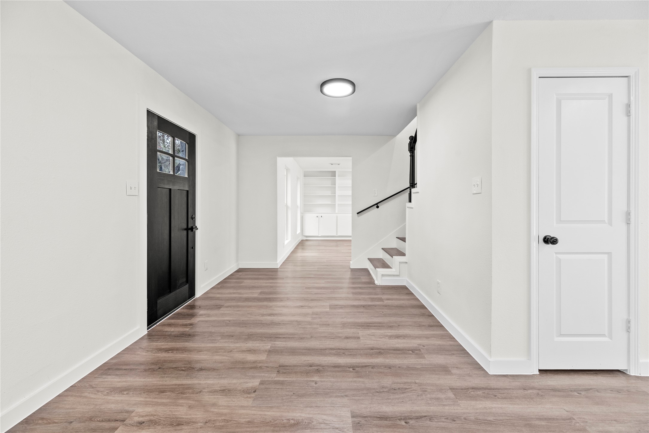 Inviting front entry offers LVP flooring and fresh paint.