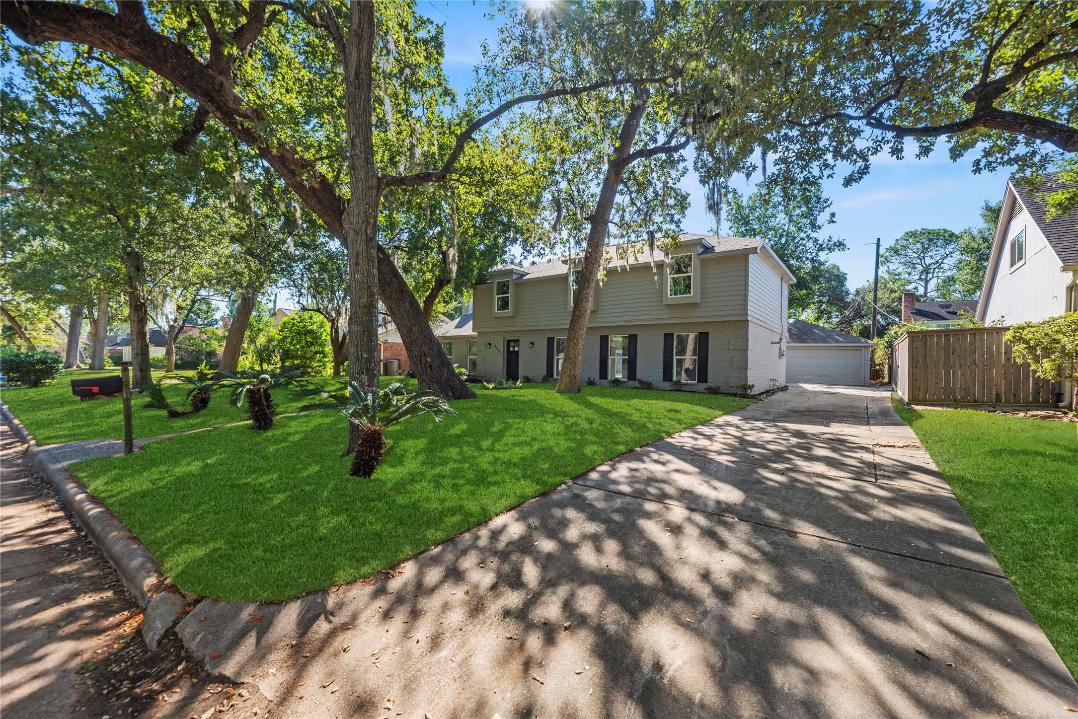 Long driveway leads to a detached 2-car garage.