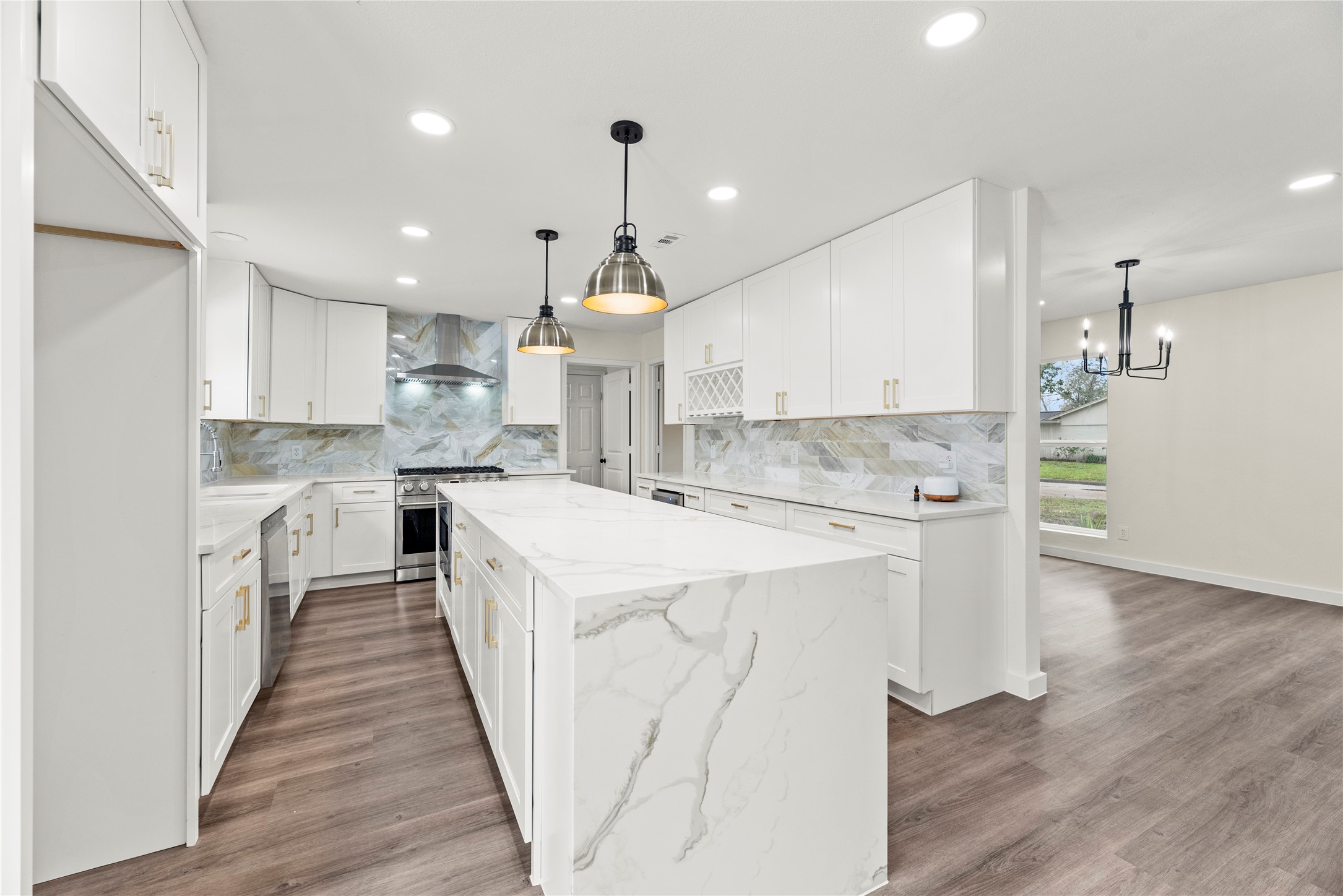 Renovated kitchen features stunning Quartz countertops, stainless steel appliances, new cabinetry, built-in wine rack, wine fridge, new fixtures and hardware.