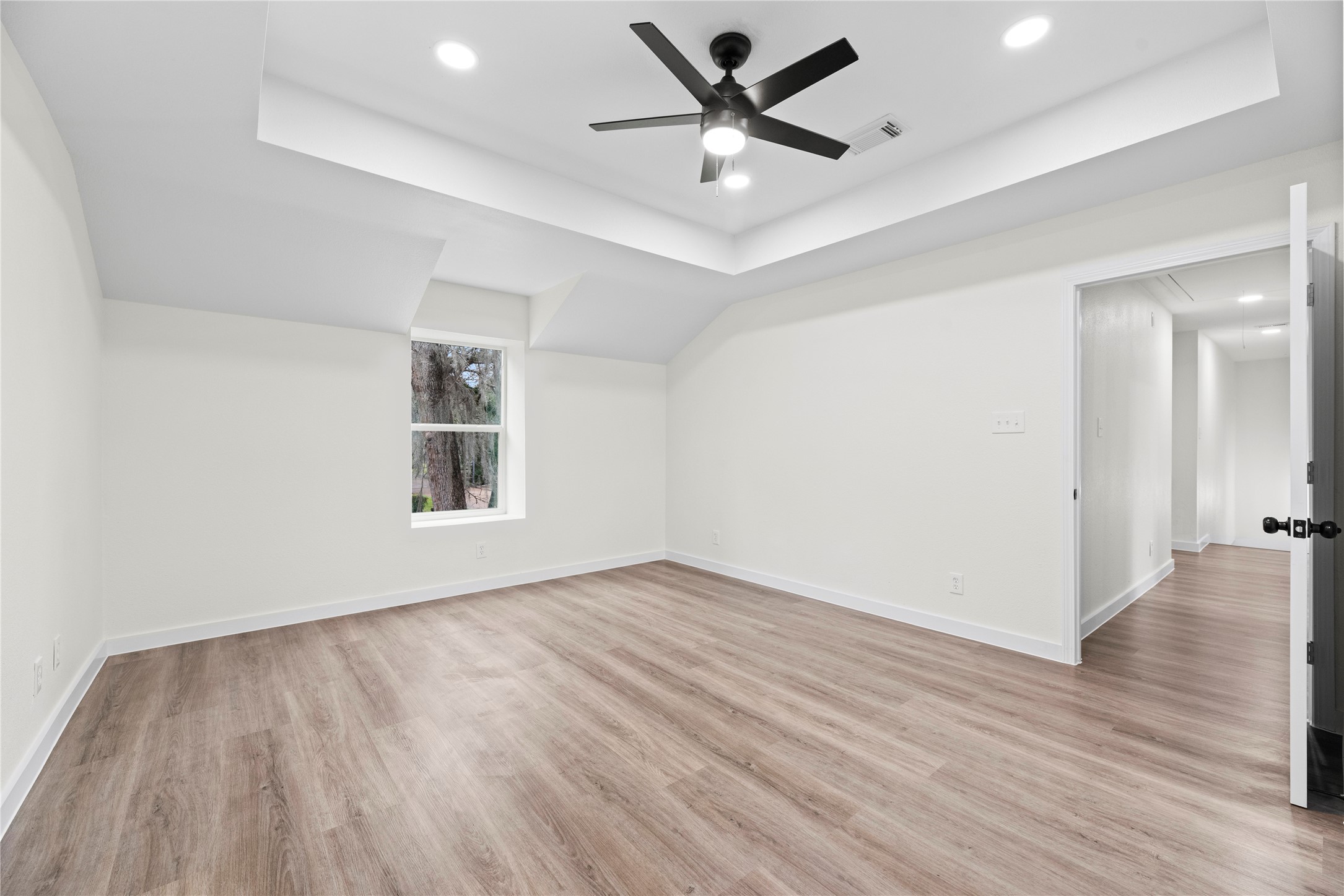 Primary bedroom conveniently located upstairs with a tray ceiling, walk-in closet and en-suite bathroom.