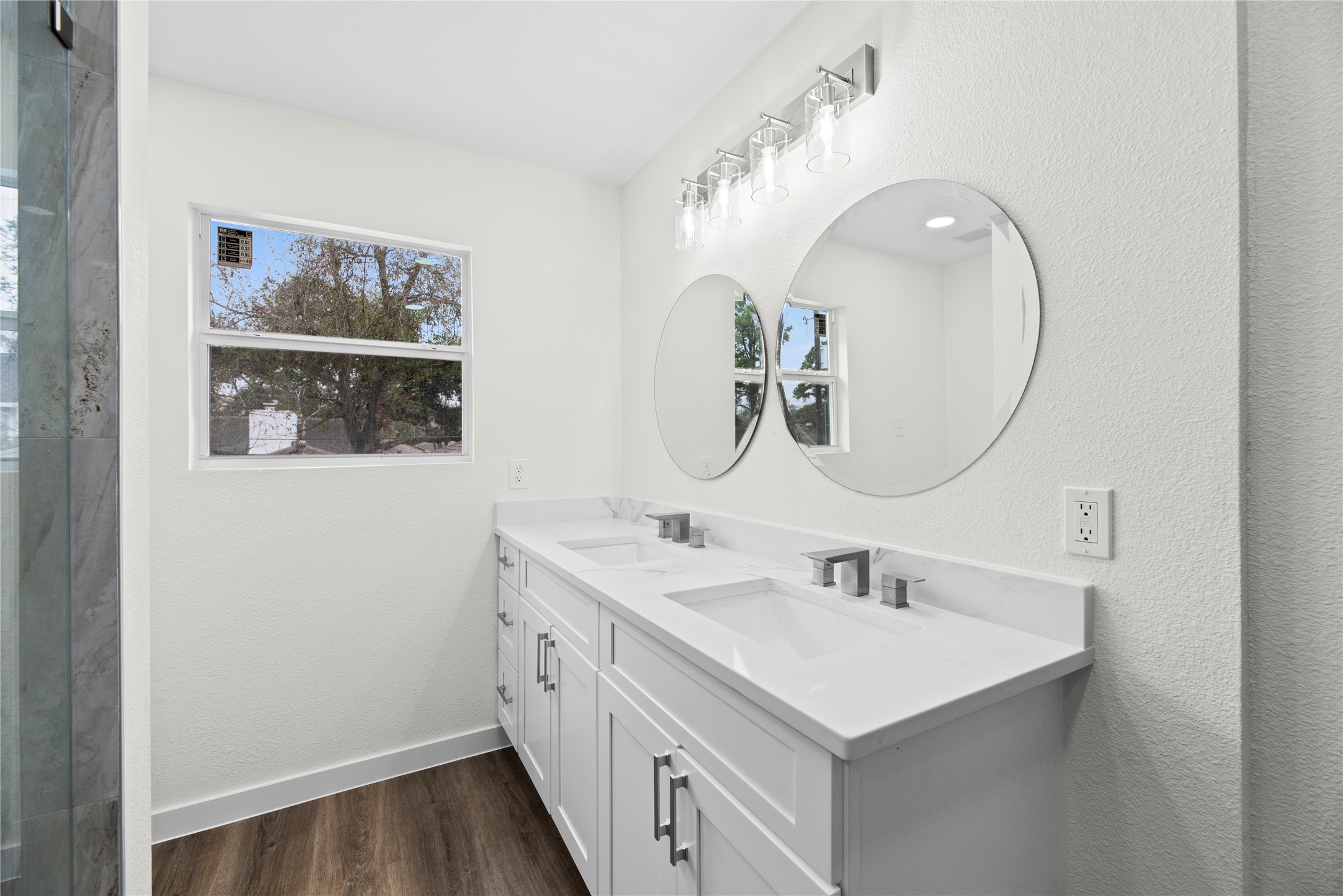 Dual sink quartz vanity with new fixtures and hardware.