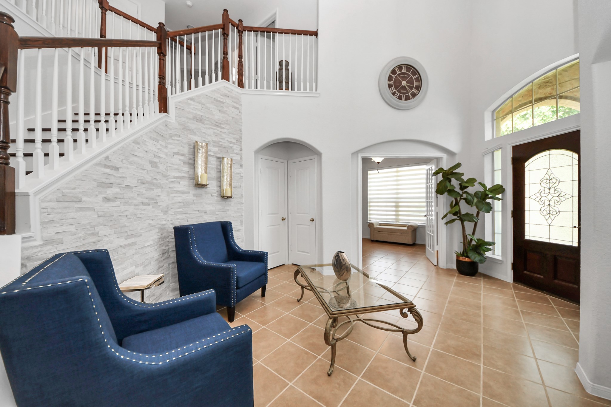 Grand foyer with soaring ceiling and an elegant staircase welcomes you into this stunning lakefront home