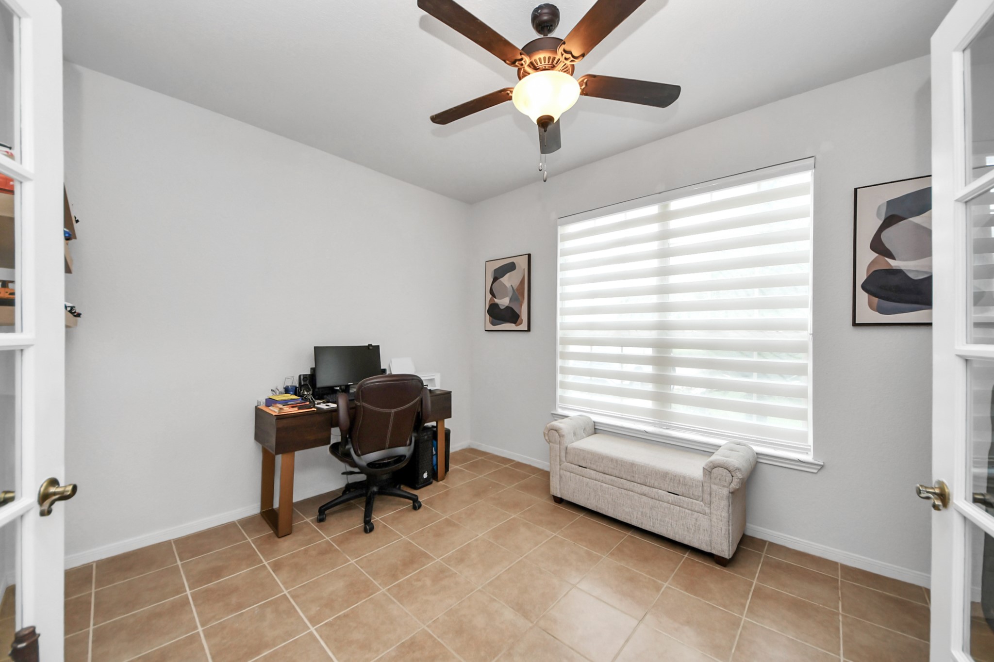 home office with two pairs of doors, one with glass and one normal doors