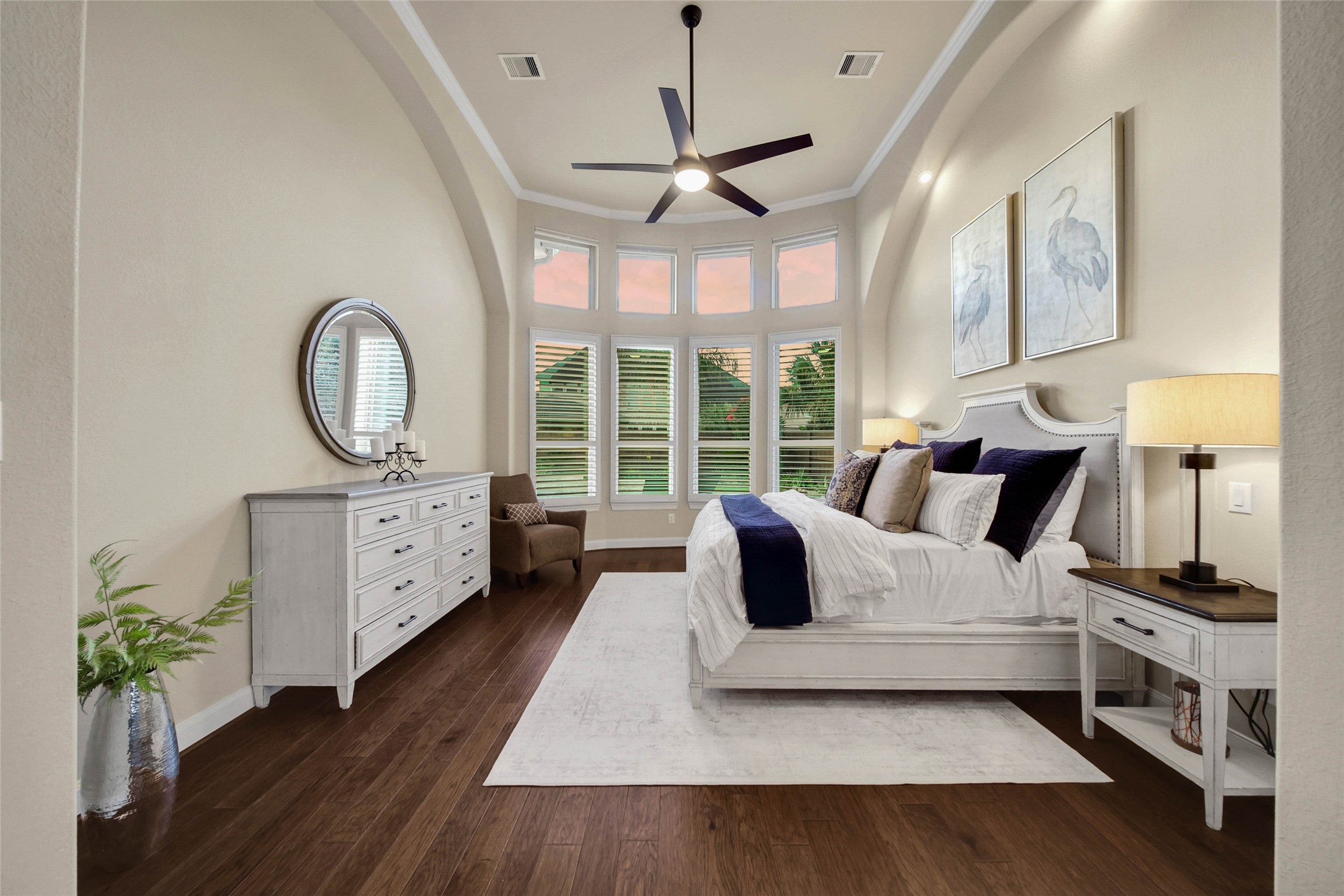 Volume ceilings enhance the primary bedroom, creating an airy, spacious feel that adds to the suites relaxing retreat-like ambiance.