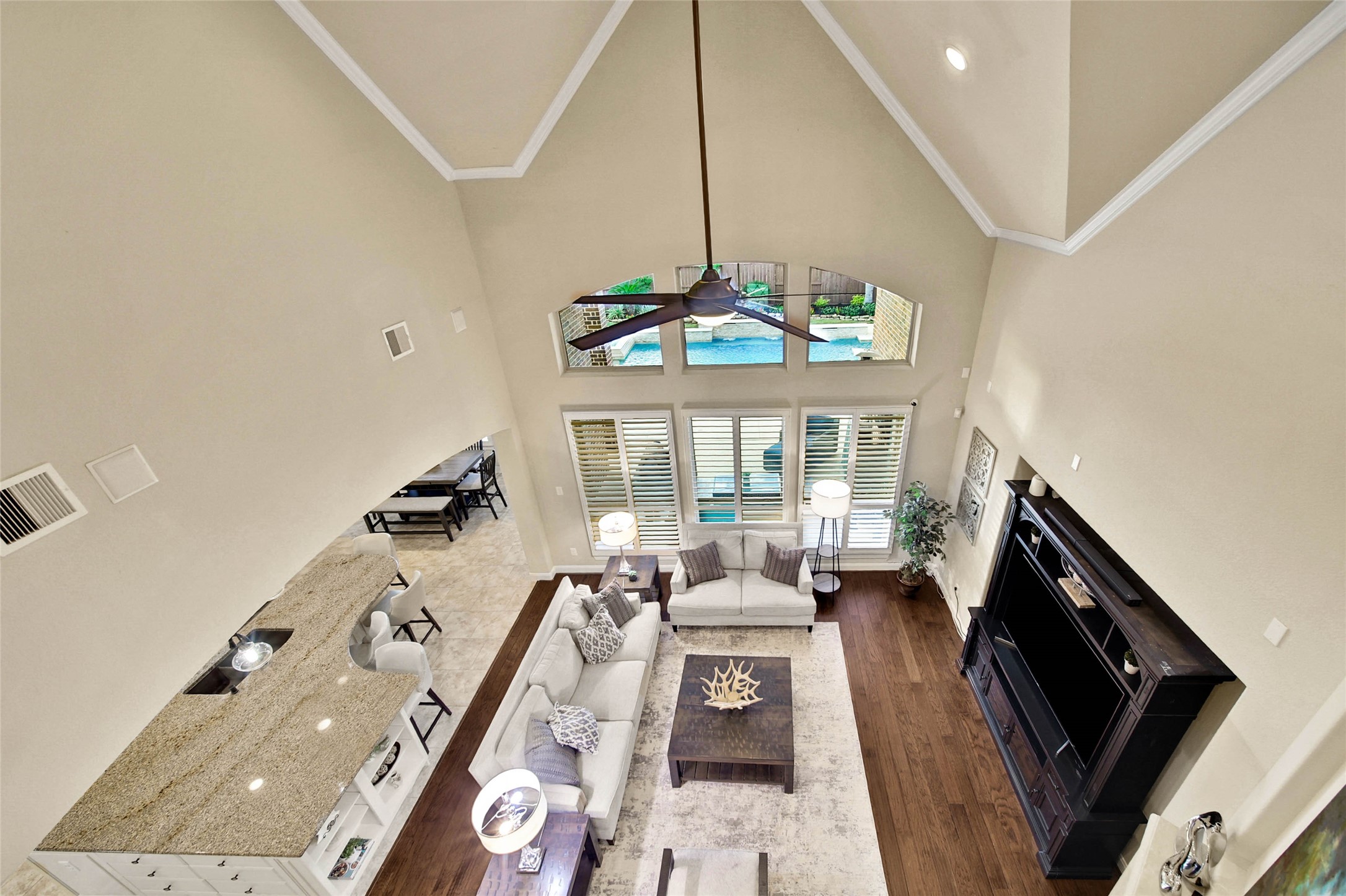 An upstairs vantage point offers a beautiful perspective of the spacious living room below, highlighting its open design and soaring ceilings.