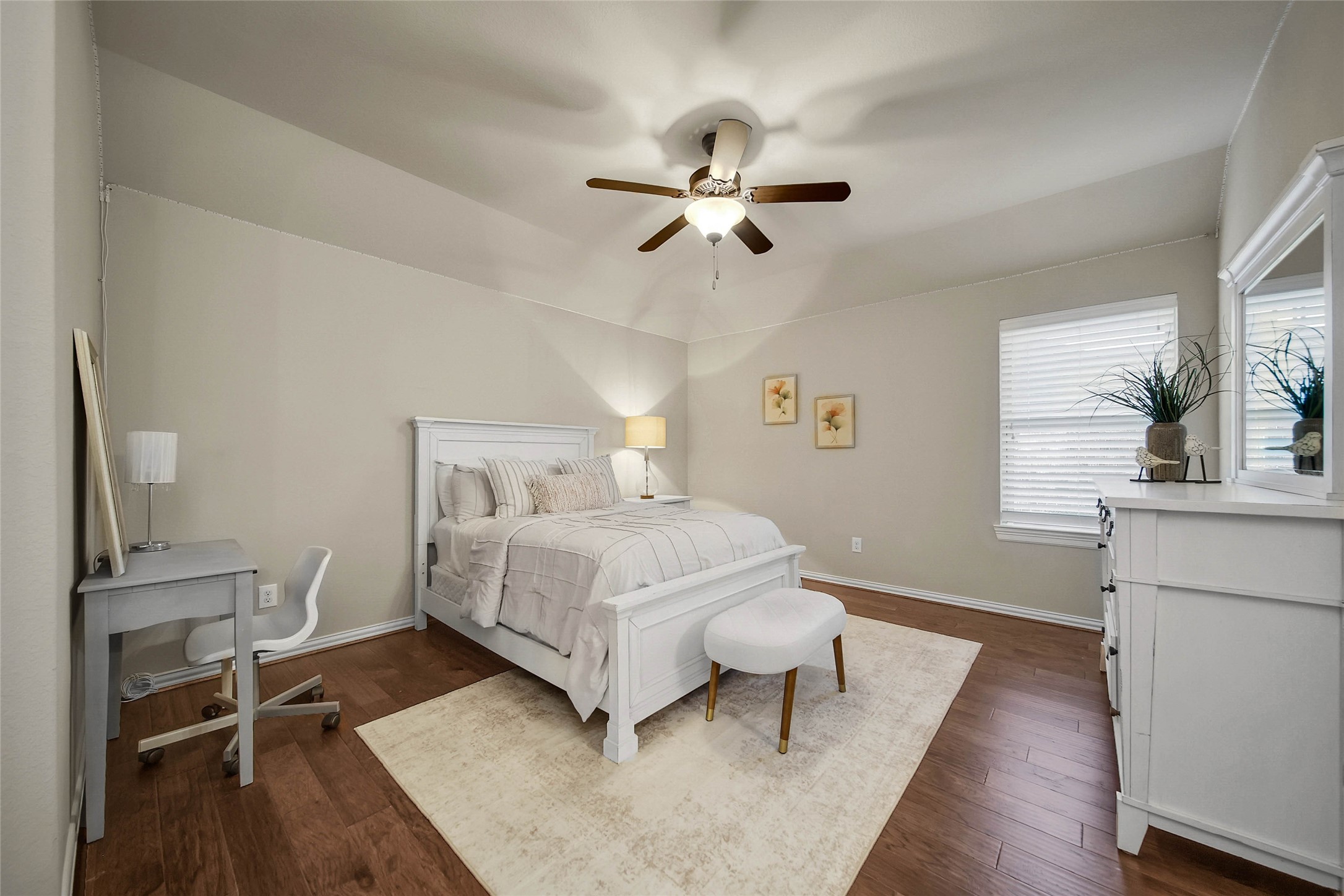 Each spacious bedroom features a neutral color palette, offering a versatile blank canvas ready for your personal style and design inspiration. This bedroom also offers a ceiling fan and walk in closet, plus private vanity area.