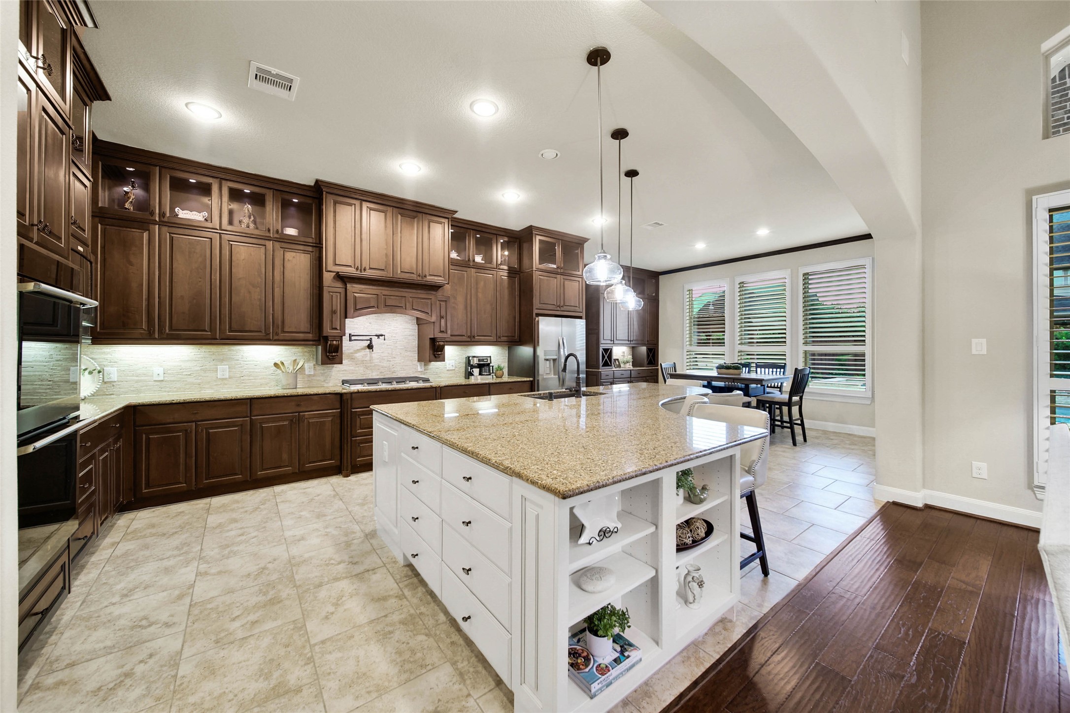 The oversized center island, accented by designer pendant lighting, is sure to become a favorite gathering spot in the home. Perfect for casual meals, entertaining guests, or simply catching up with family while preparing dinner!