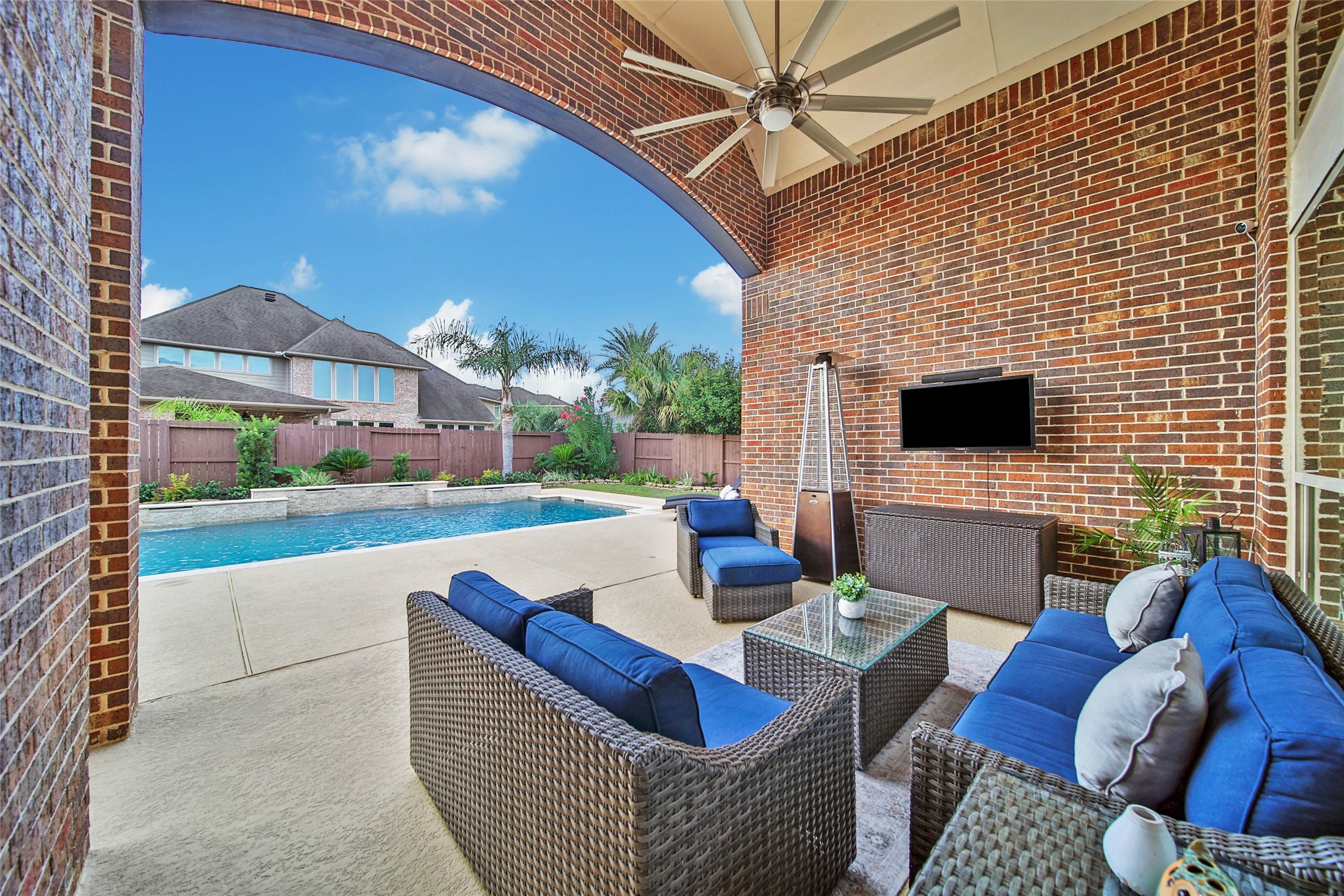 Step outside to one of the inviting covered patio areas, where lovely views of the backyard and pool create the perfect setting for relaxing or entertaining year-round.