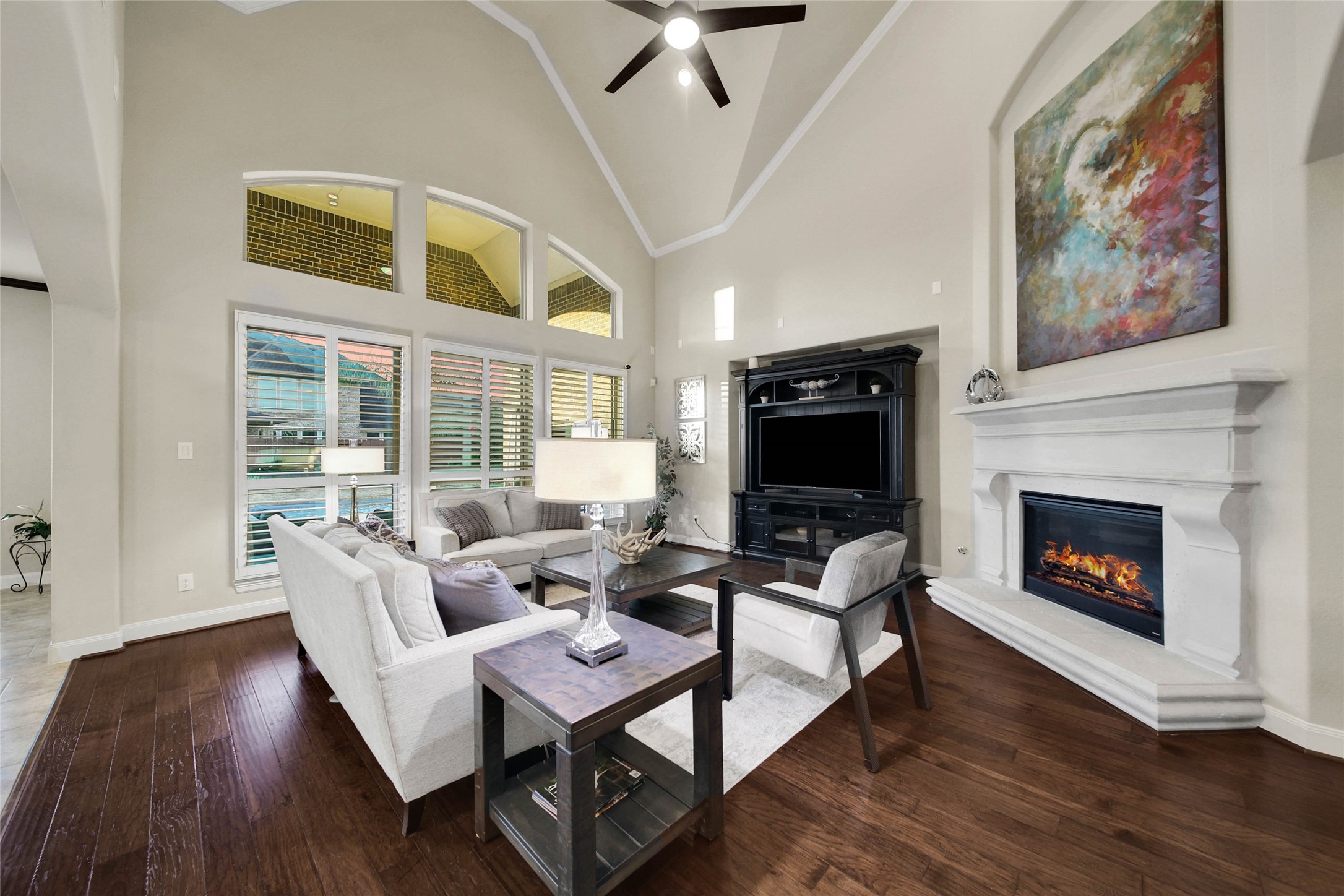 The cast-stone fireplace with gas logs creates a stunning focal point in the living room, adding character and warmth to the space.