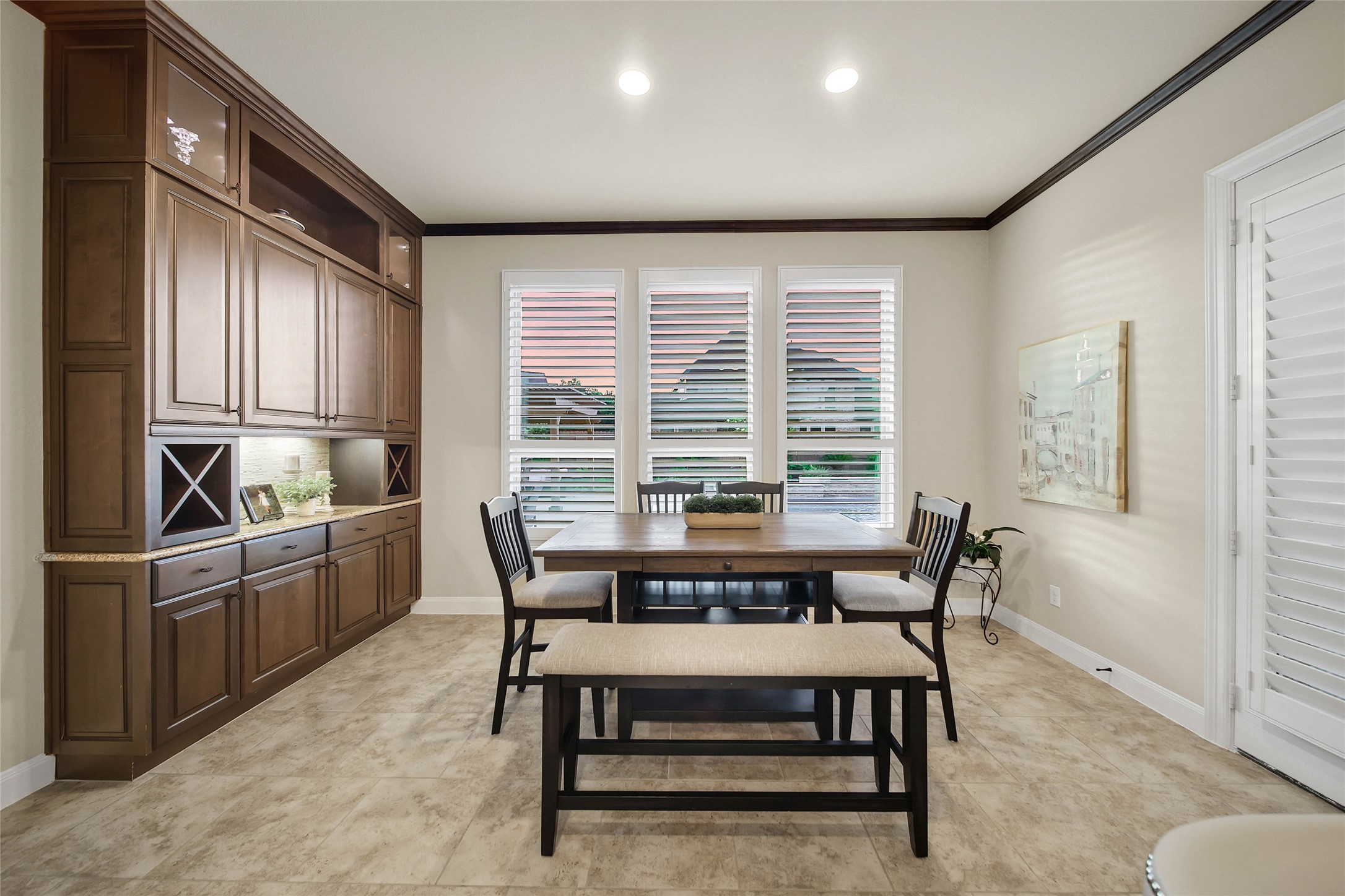 The breakfast rooms built-in buffet counter and cabinetry are a fabulous upgrade, offering convenient storage and the perfect serving station for meals. An oversized utility room with built ins and space for a 2nd refrigerator is located just off the breakfast nook.