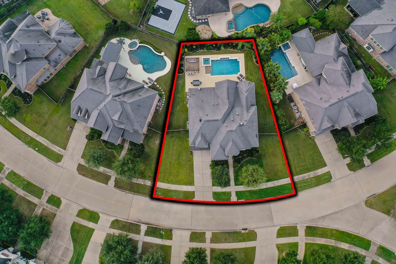 This generous 13,575-square-foot lot offers abundant space to entertain in your outdoor oasis.