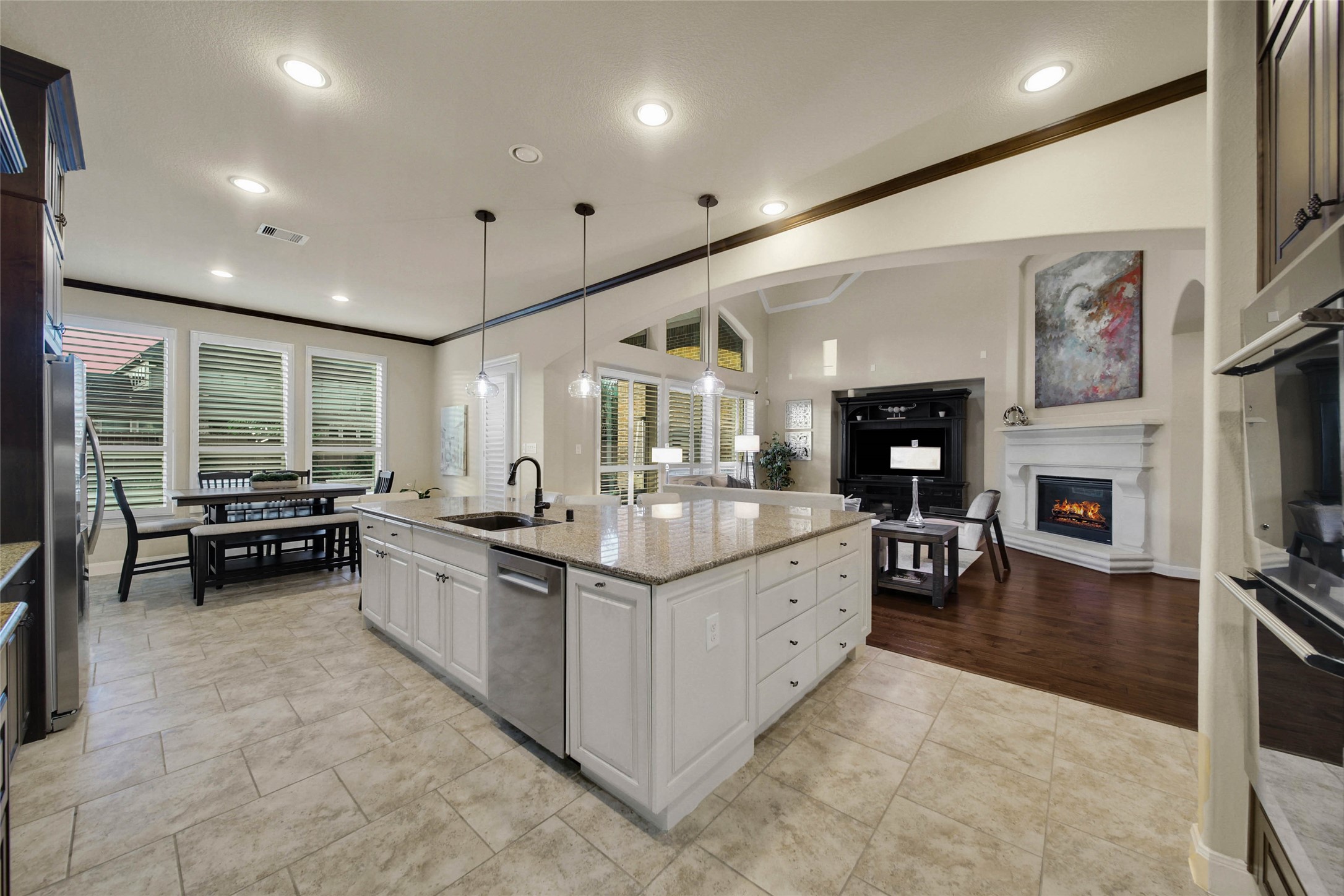 The kitchen opens seamlessly to the living room, creating an inviting, open-concept space where everyone can stay connected and part of the conversation, whether cooking, relaxing, or entertaining.
