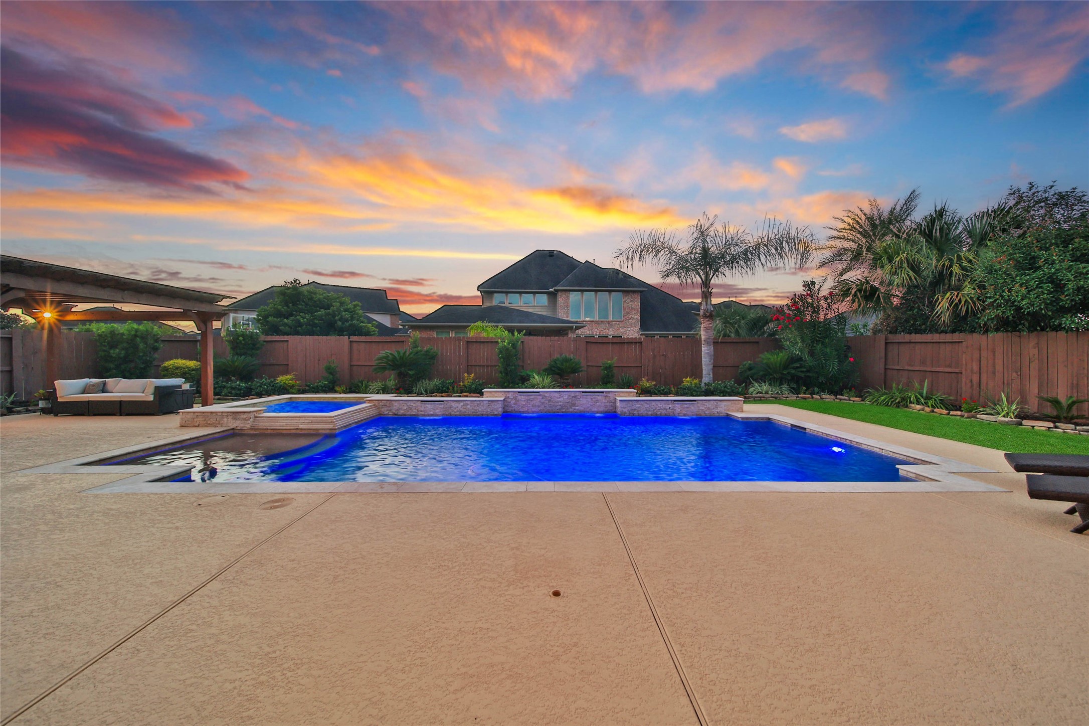 The approximately 24,000-gallon heated saltwater pool and spa create a stunning backyard oasis, while three sheer-descent waterfalls provide the soothing sounds of cascading water for a truly relaxing retreat.