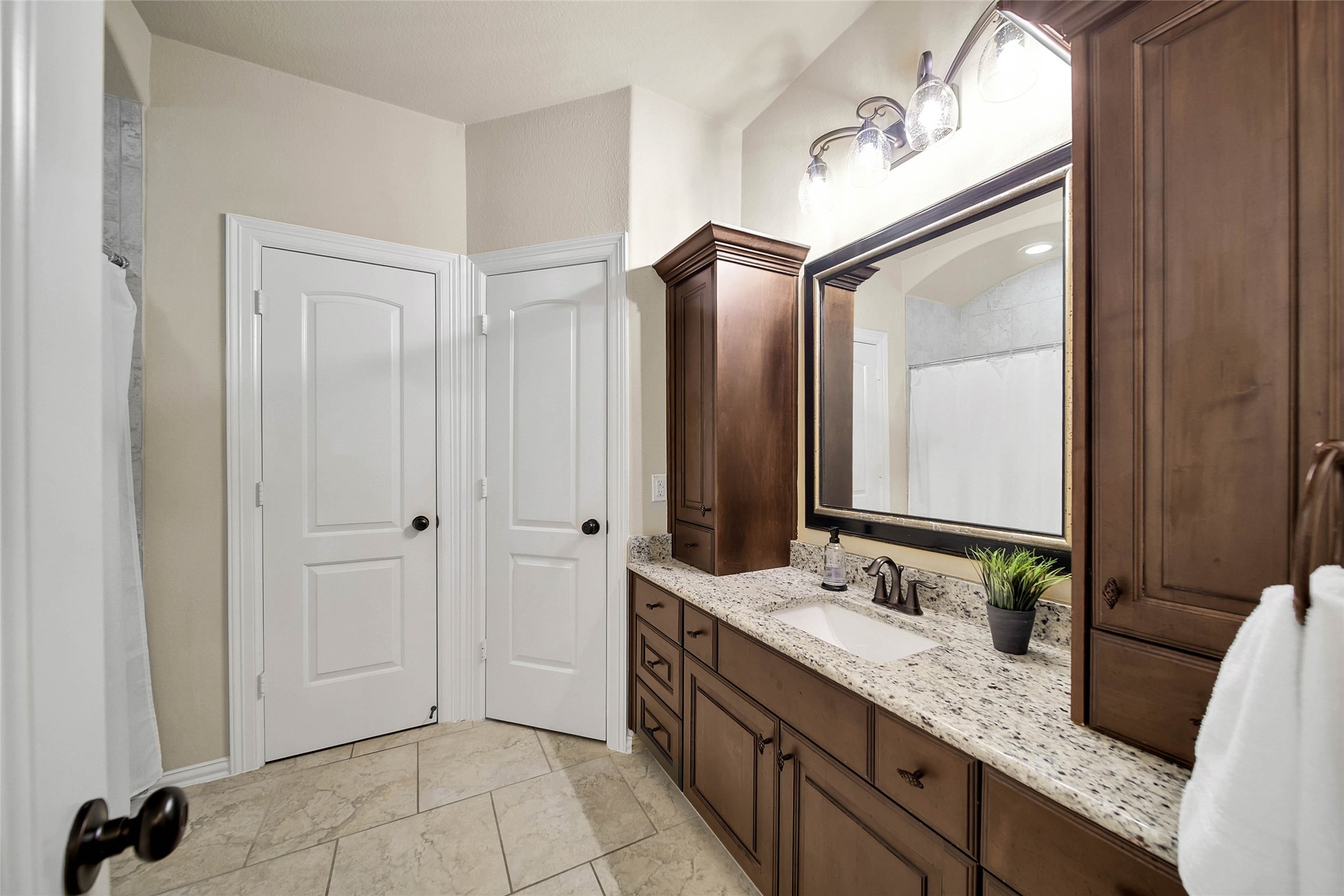 Conveniently located off the game room, this bathroom also provides direct access to one of the three upstairs bedrooms, offering added privacy and functionality.