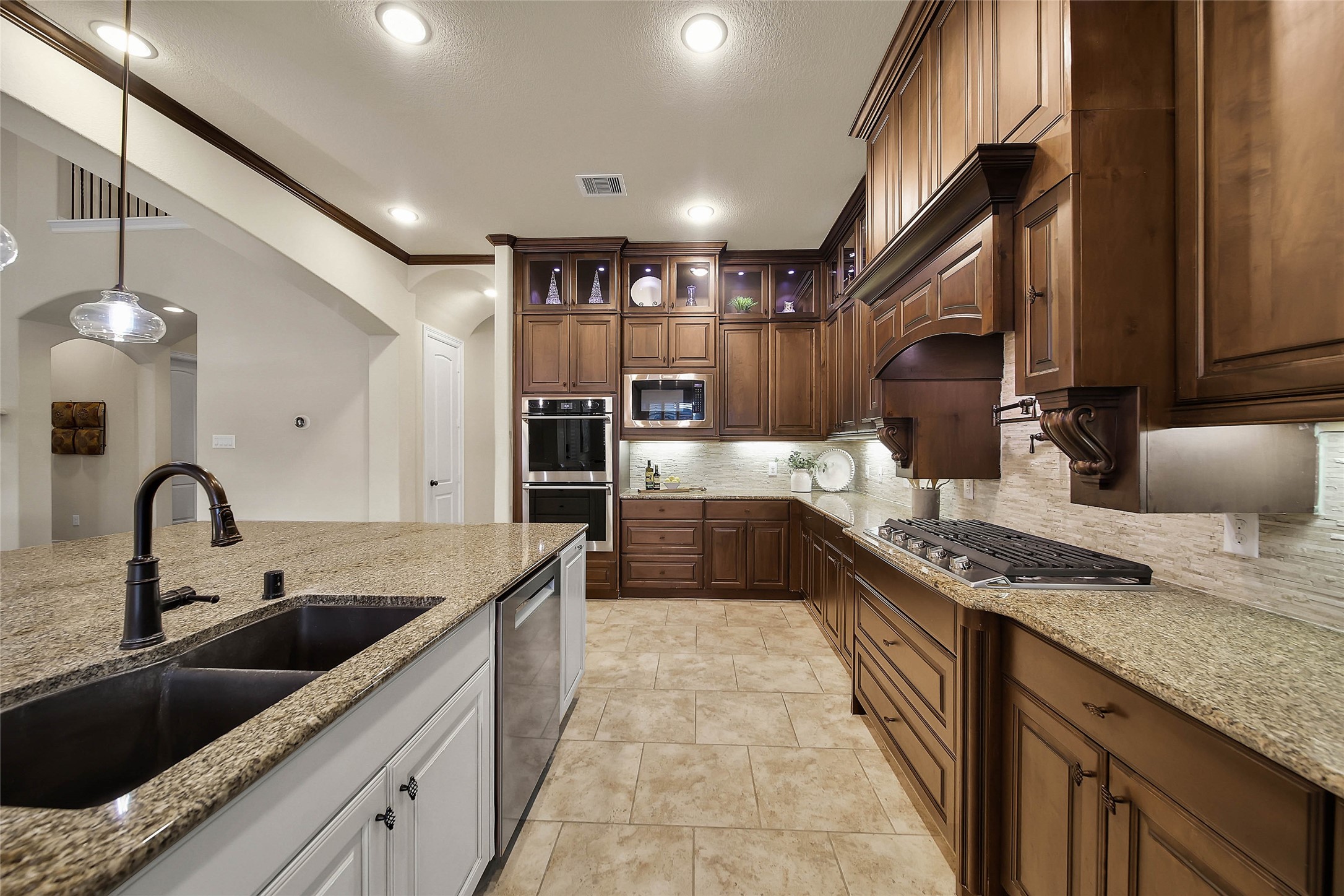 Electrolux double ovens (2026) and a Bosch dishwasher (2025) complete the suite of stainless steel appliances, adding both style and functionality to this well-appointed kitchen.