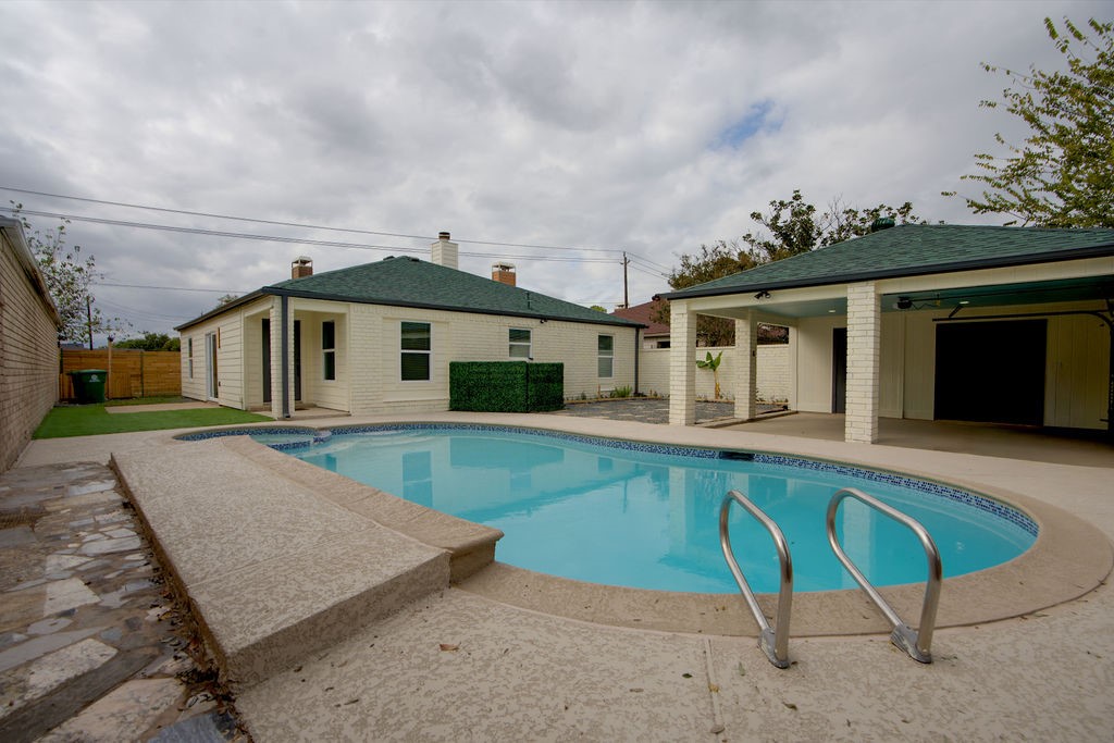 Charming home with a spacious backyard featuring a sparkling pool, perfect for relaxation and outdoor gatherings.