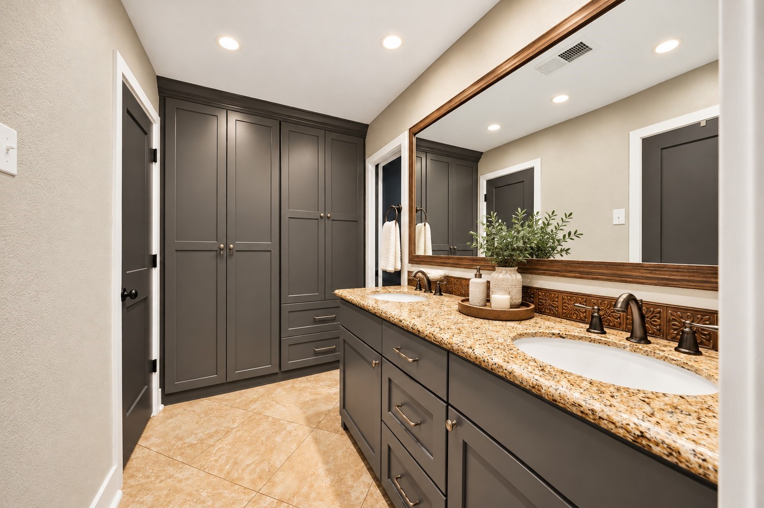 Bathroom with Double Vanity (Virtually Staged)
Spacious bathroom showcasing dual sinks, granite countertops, modern gray cabinetry, an oversized framed mirror, and extensive built-in storage. A perfect blend of style and everyday functionality.