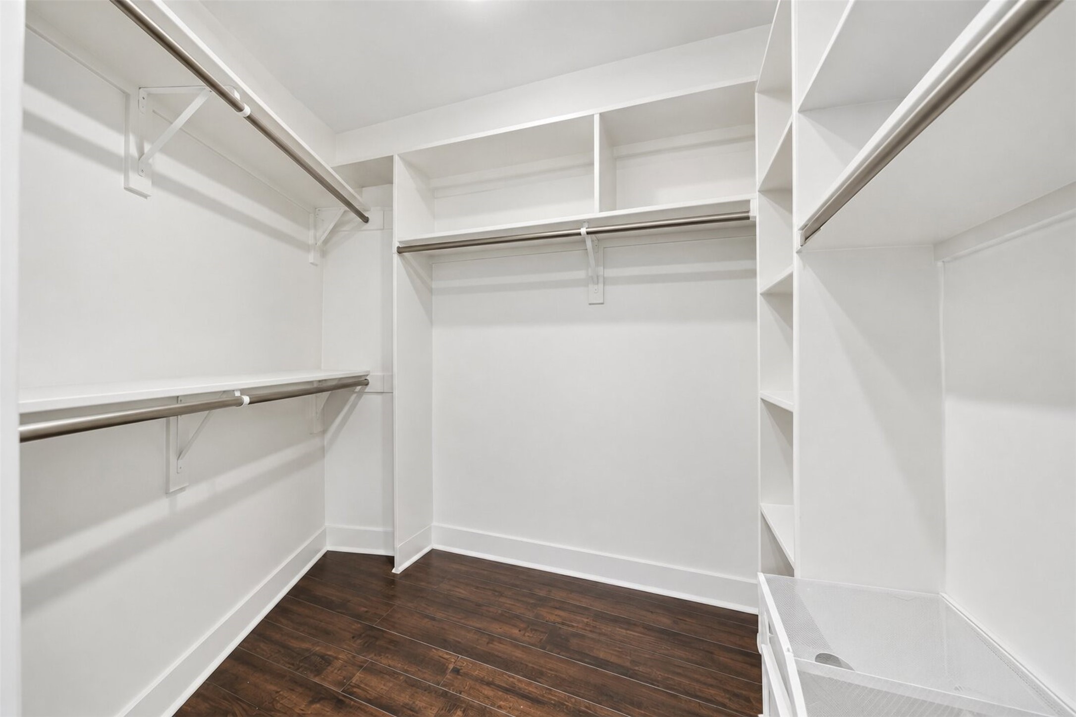 Walk-In Closet
Spacious walk-in closet featuring custom-style built-in shelving, multiple hanging areas, and generous storage space for effortless organization.