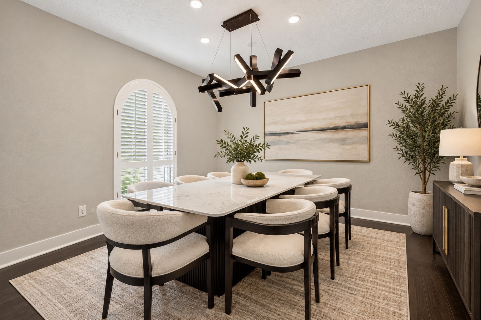Formal Dining Room (Virtually Staged)
Elegant formal dining room featuring beautiful wood flooring, a distinctive arched window with plantation shutters, and a statement chandelier. A sophisticated setting for hosting memorable gatherings.