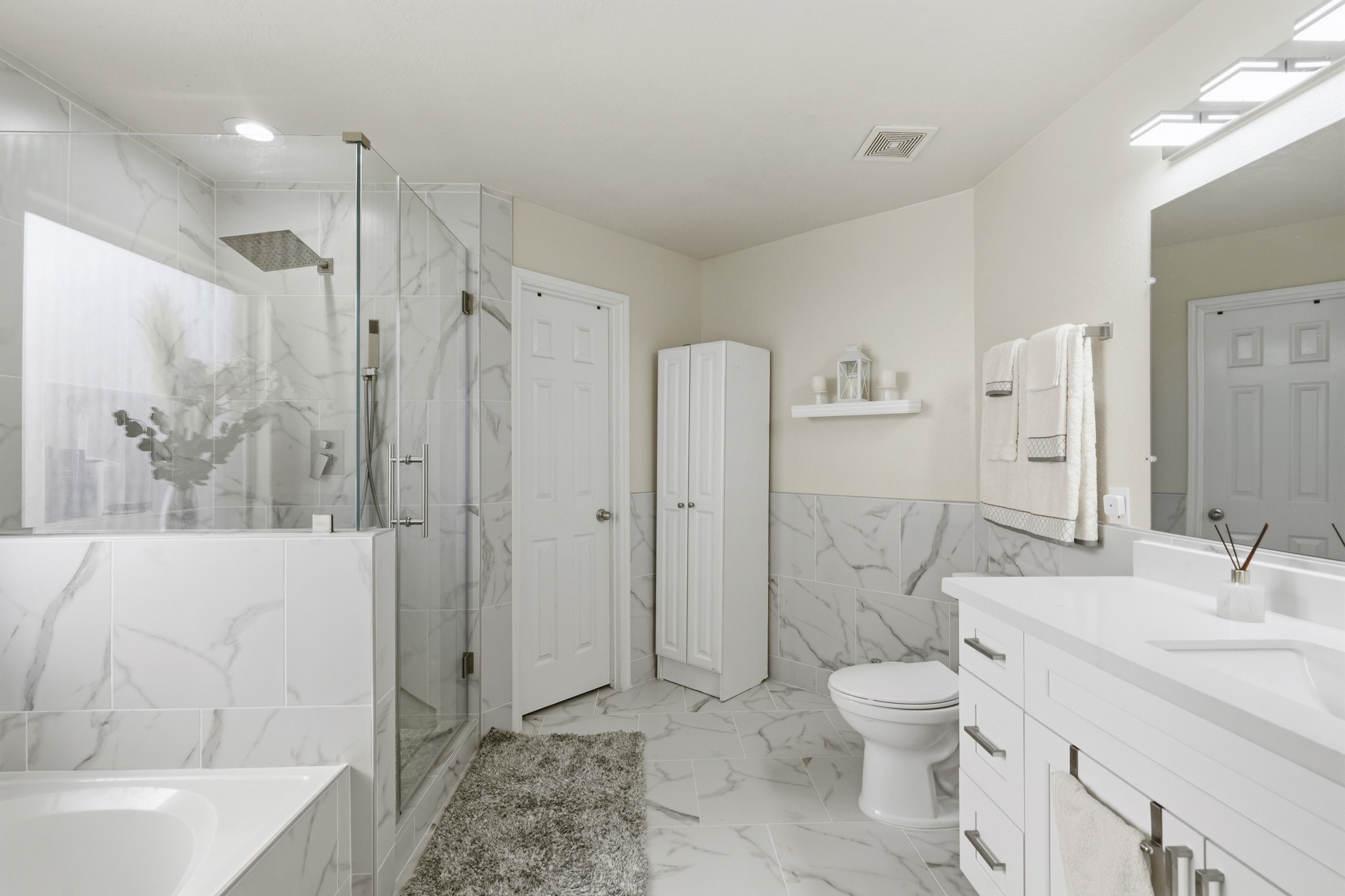 Completely remodeled, the primary bathroom offers a fresh, polished retreat with updated finishes and a relaxing soaking tub.