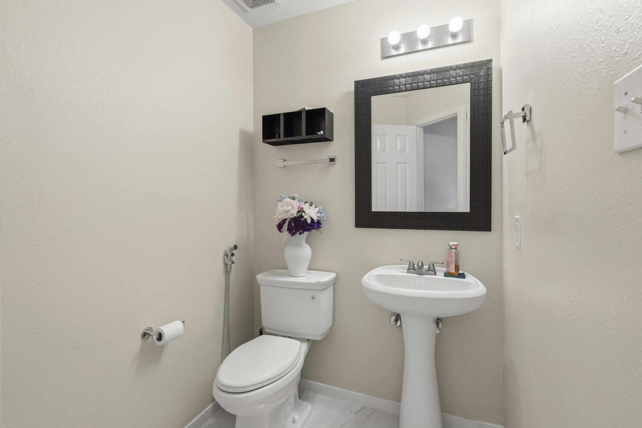 A convenient half bath serves guests and the main living areas.