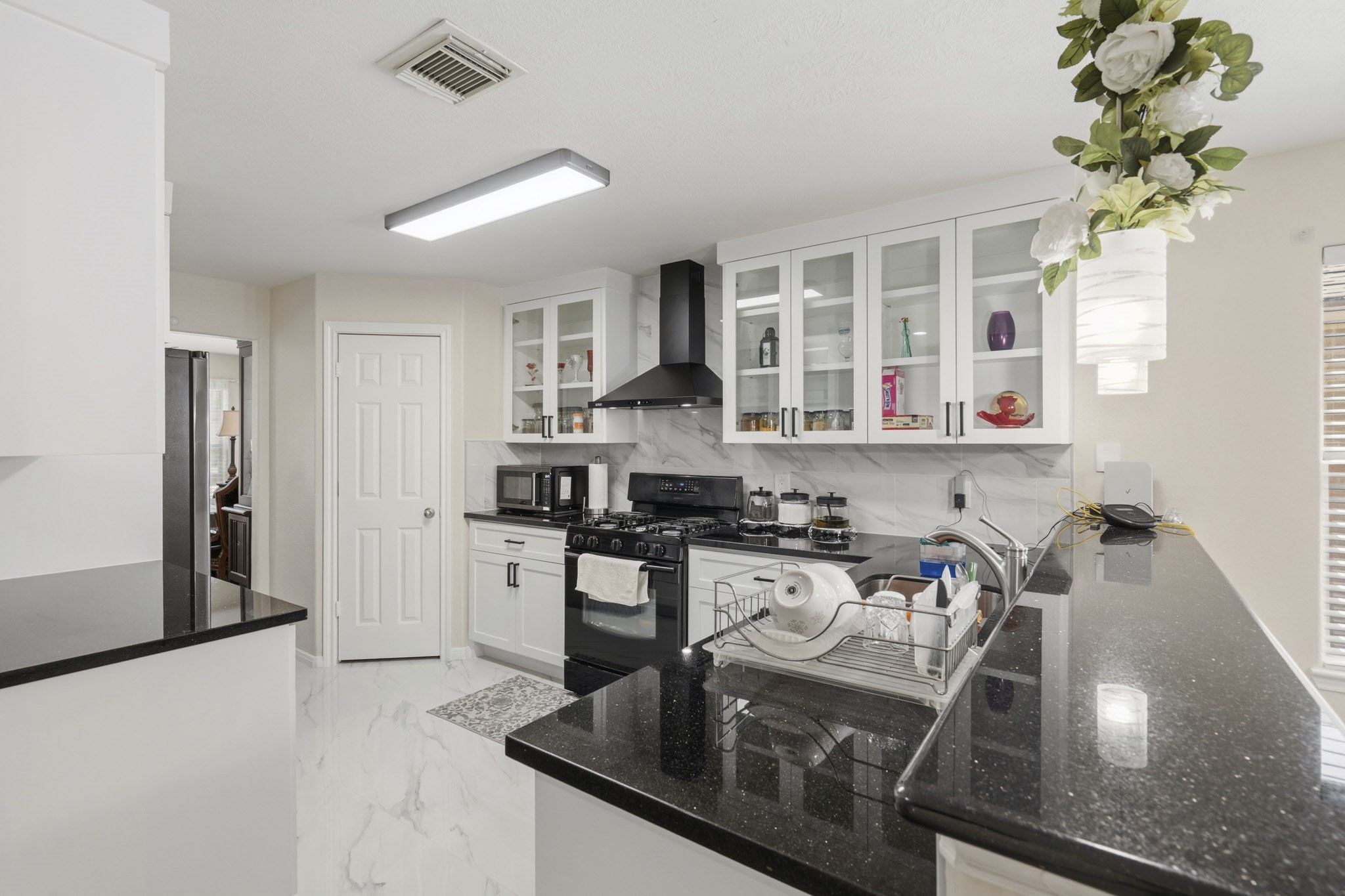The remodeled kitchen pairs crisp white cabinetry, granite countertops, abundant workspace and a large island for prep and serving. The remodeled kitchen pairs crisp white cabinetry, granite countertops, abundant workspace and a large island for prep and serving.