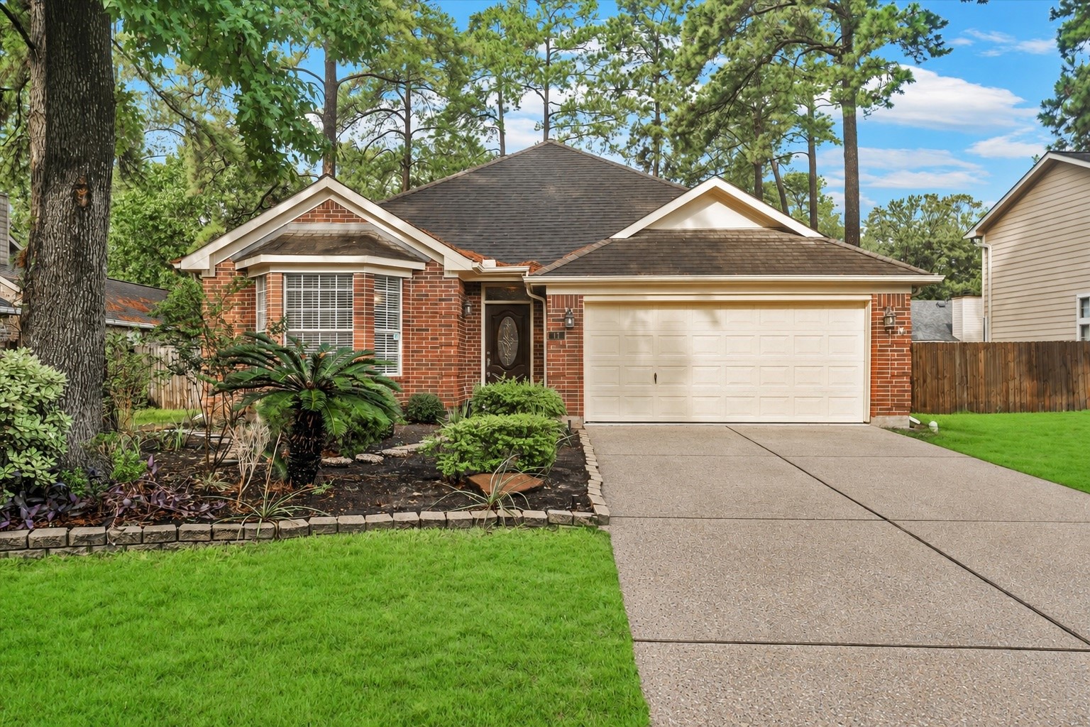 Charming brick home with a welcoming front yard, lush landscaping, and a spacious two-car garage, nestled in a serene neighborhood surrounded by mature trees. Charming brick home with a welcoming front yard, lush landscaping, and a spacious two-car garage, nestled in a serene neighborhood surrounded by mature trees.