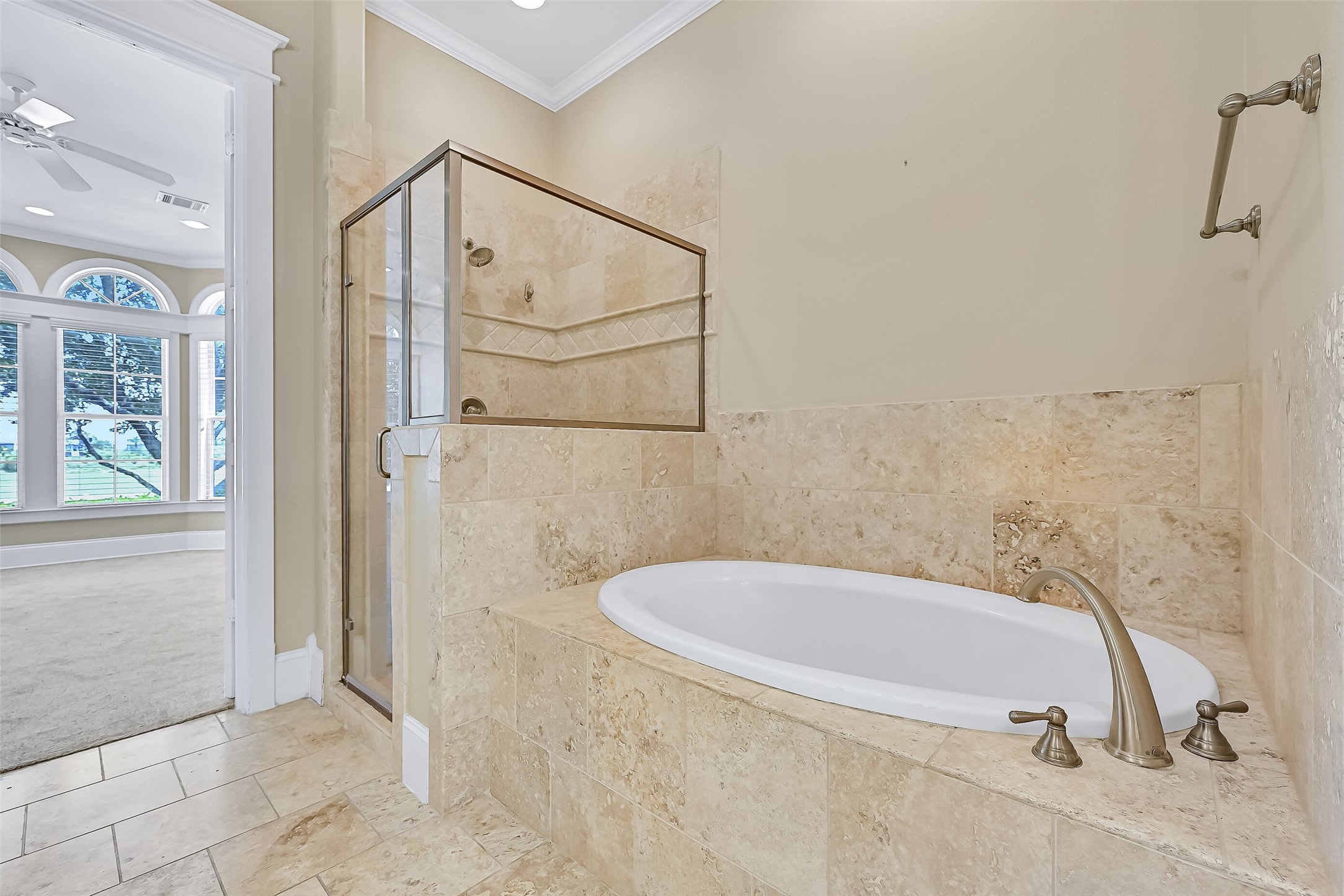Glass-framed walk-in shower and soaking tub.