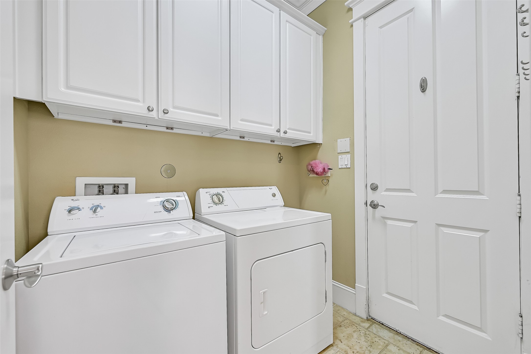 Laundry room accessed from the kitchen. The door access the 2 car garage.