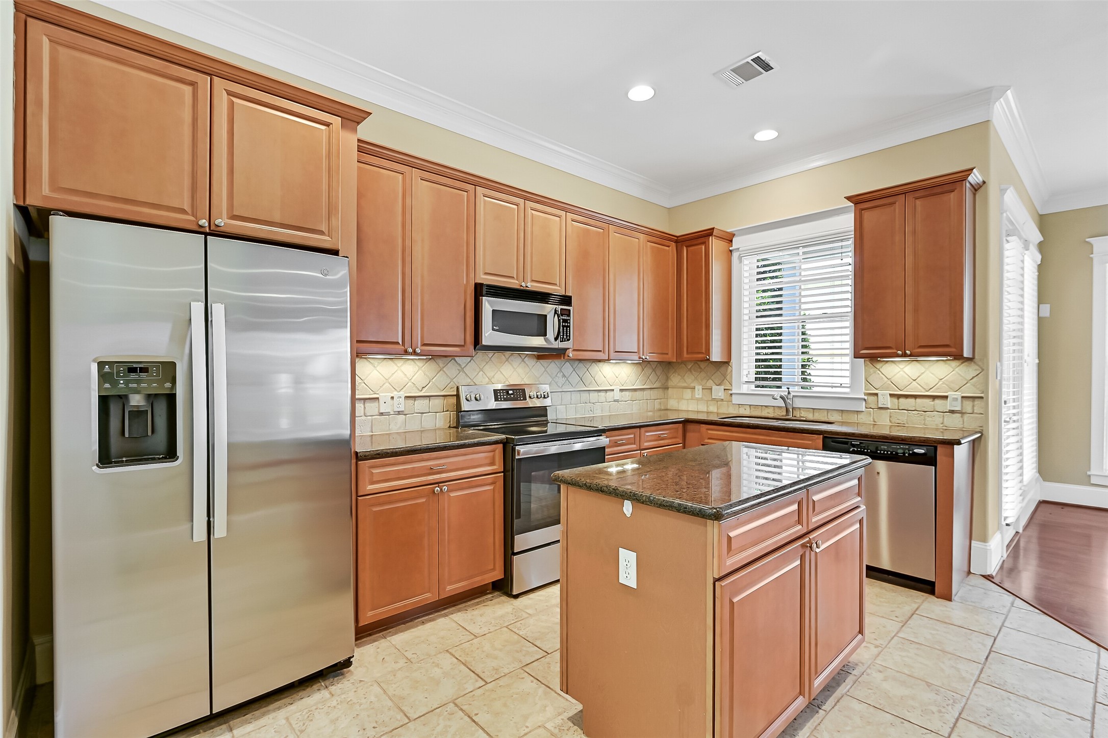 Notice the undercabinet lighting and sparkling granite counter tops.