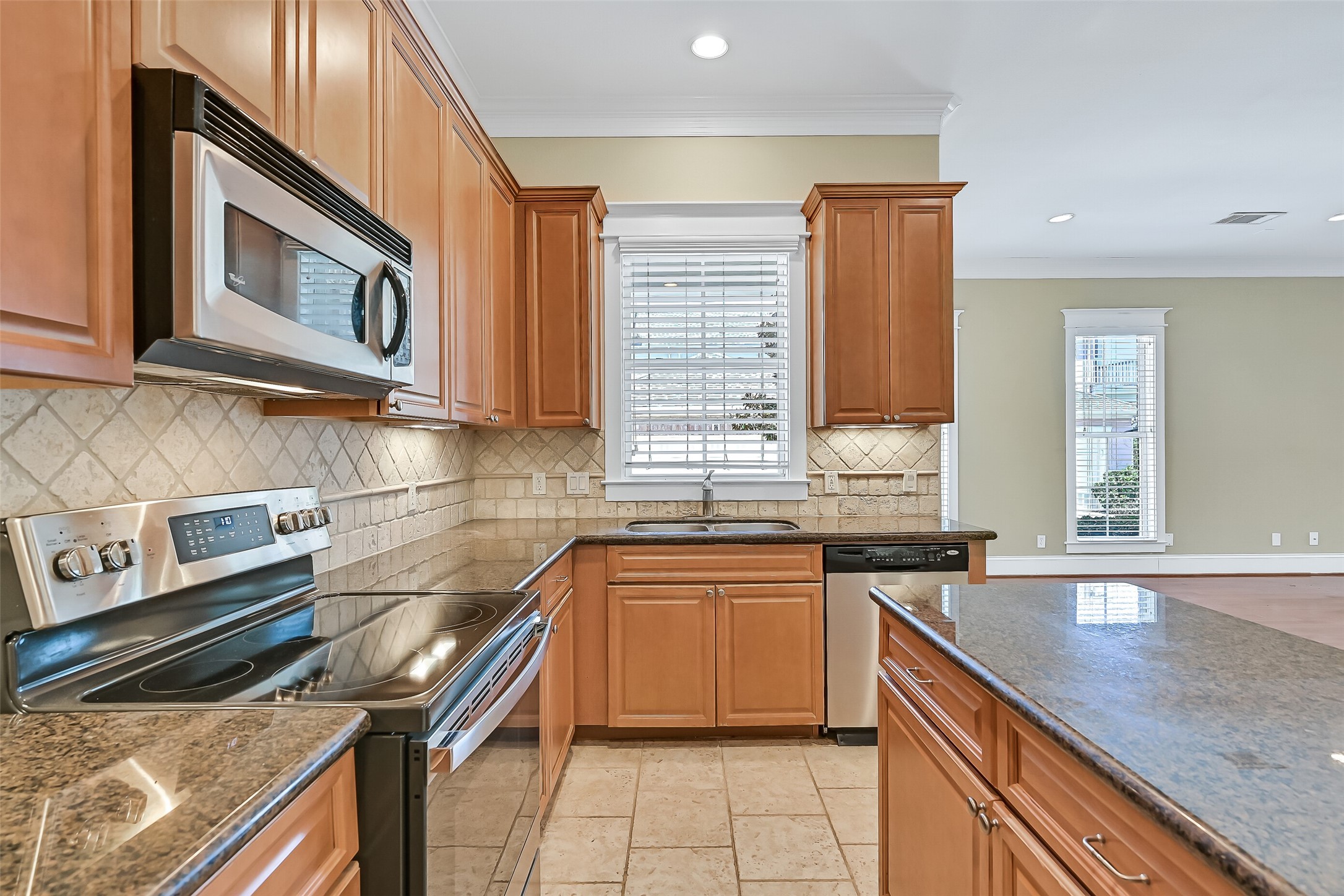 As well as the travertine backsplash. This kitchen was designed for ease of everyday living. A full suite of stainless appliances is included!
