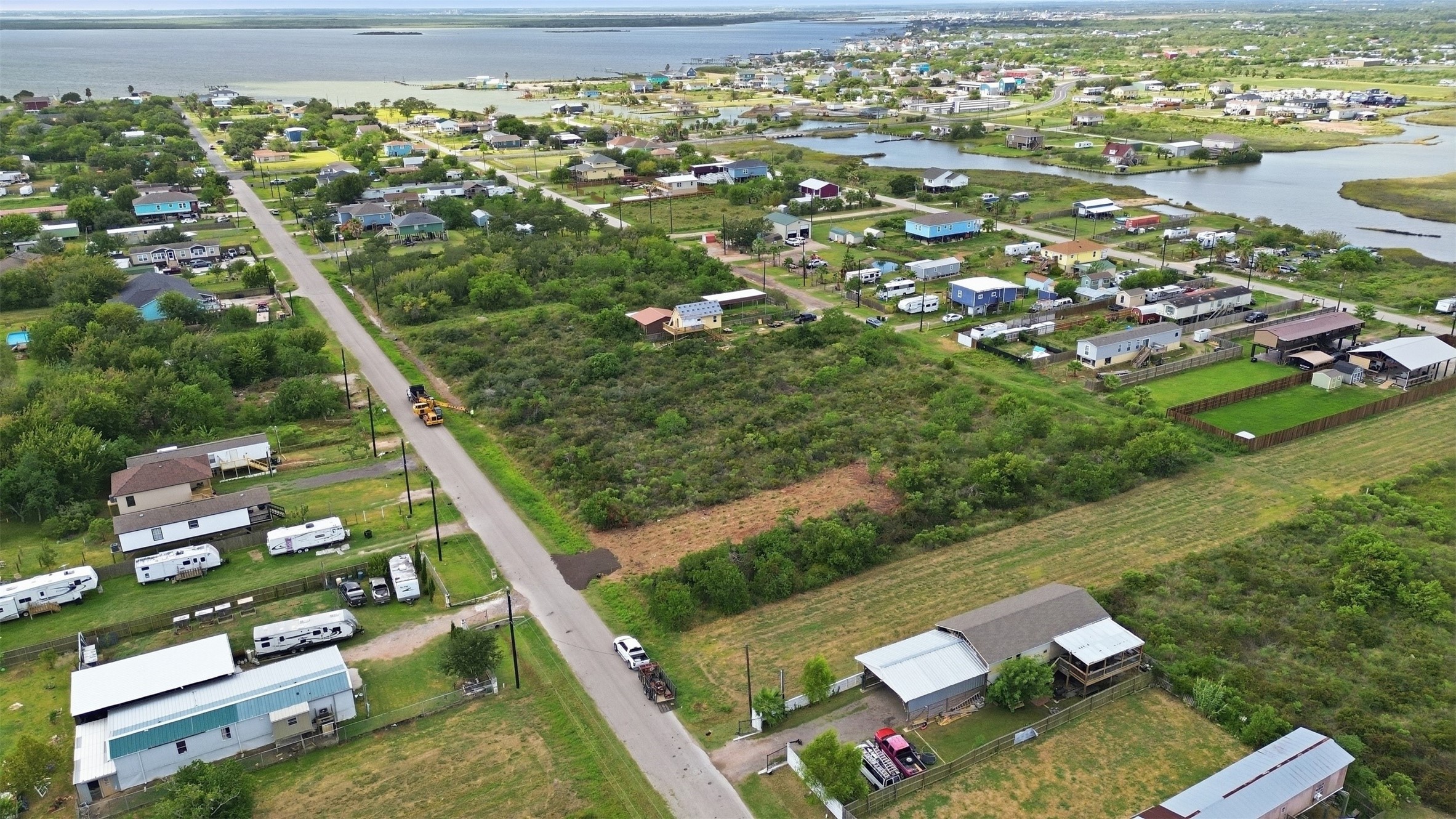 Aerial showing the property's position in the neighborhood, with Galveston Bay and a tidal channel nearby. This view shows how close the tract is to the water.