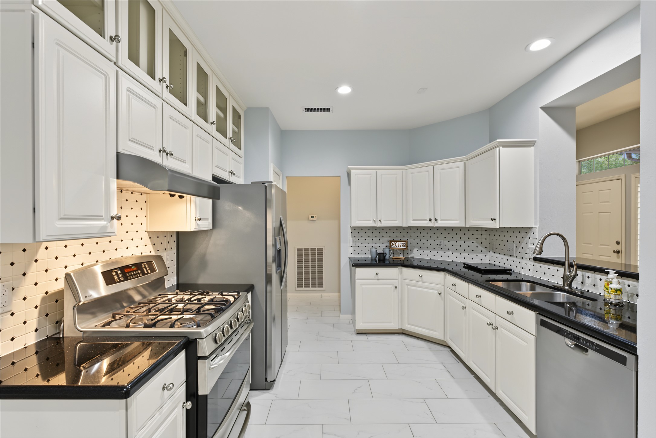 Gas range and well appointed kitchen