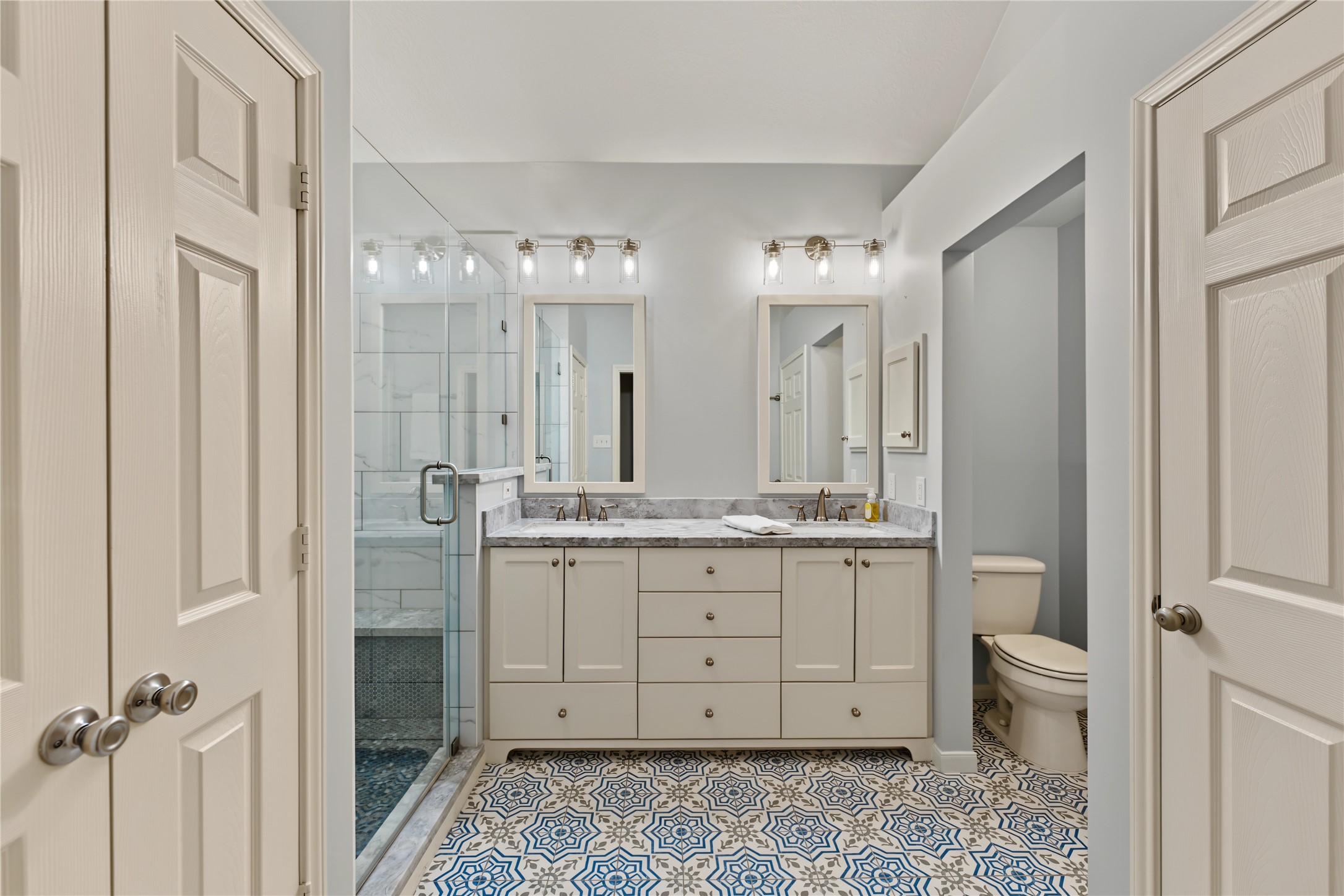 Primary bathroom with dual sinks, quartz countertops, beautiful tile floors!