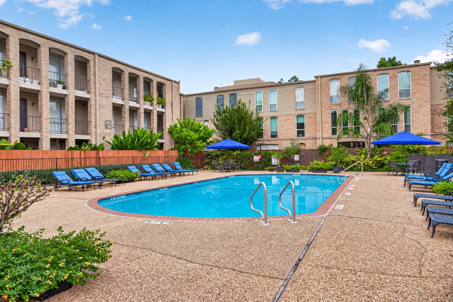 Relax and enjoy the community swimming pool, surrounded by attractive landscaping, lounge seating, and outdoor gathering areas.
