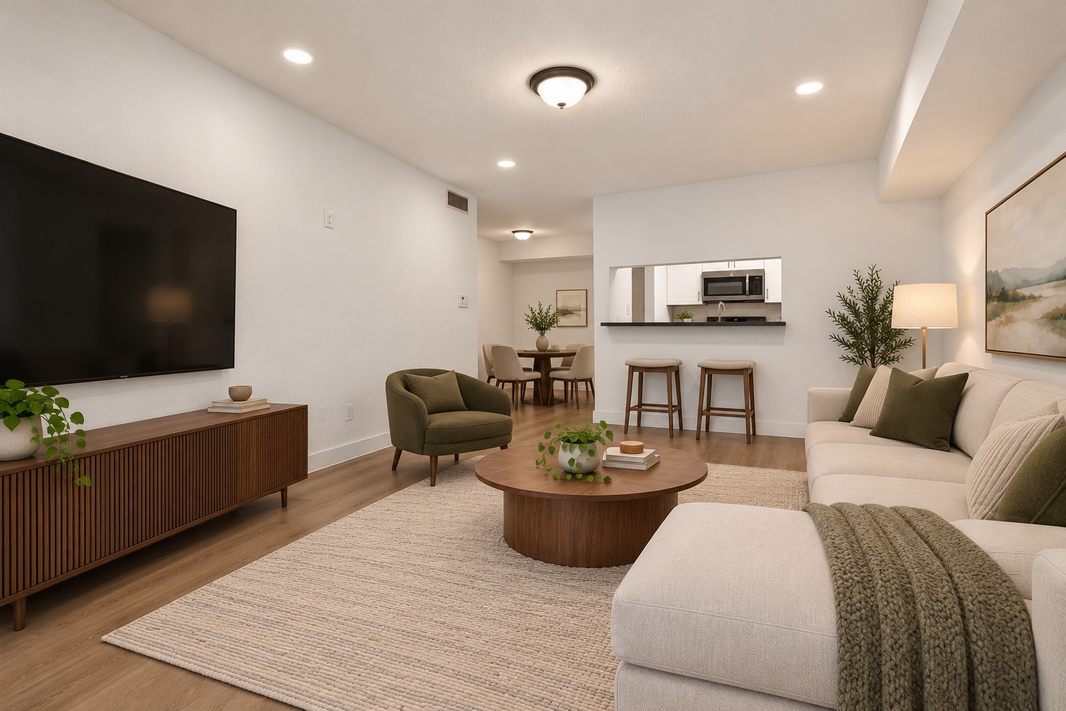 A spacious, inviting living area with new laminate flooring and an easy connection to the kitchen and dining space. Furniture virtually staged. A spacious, inviting living area with new laminate flooring and an easy connection to the kitchen and dining space. Furniture virtually staged.