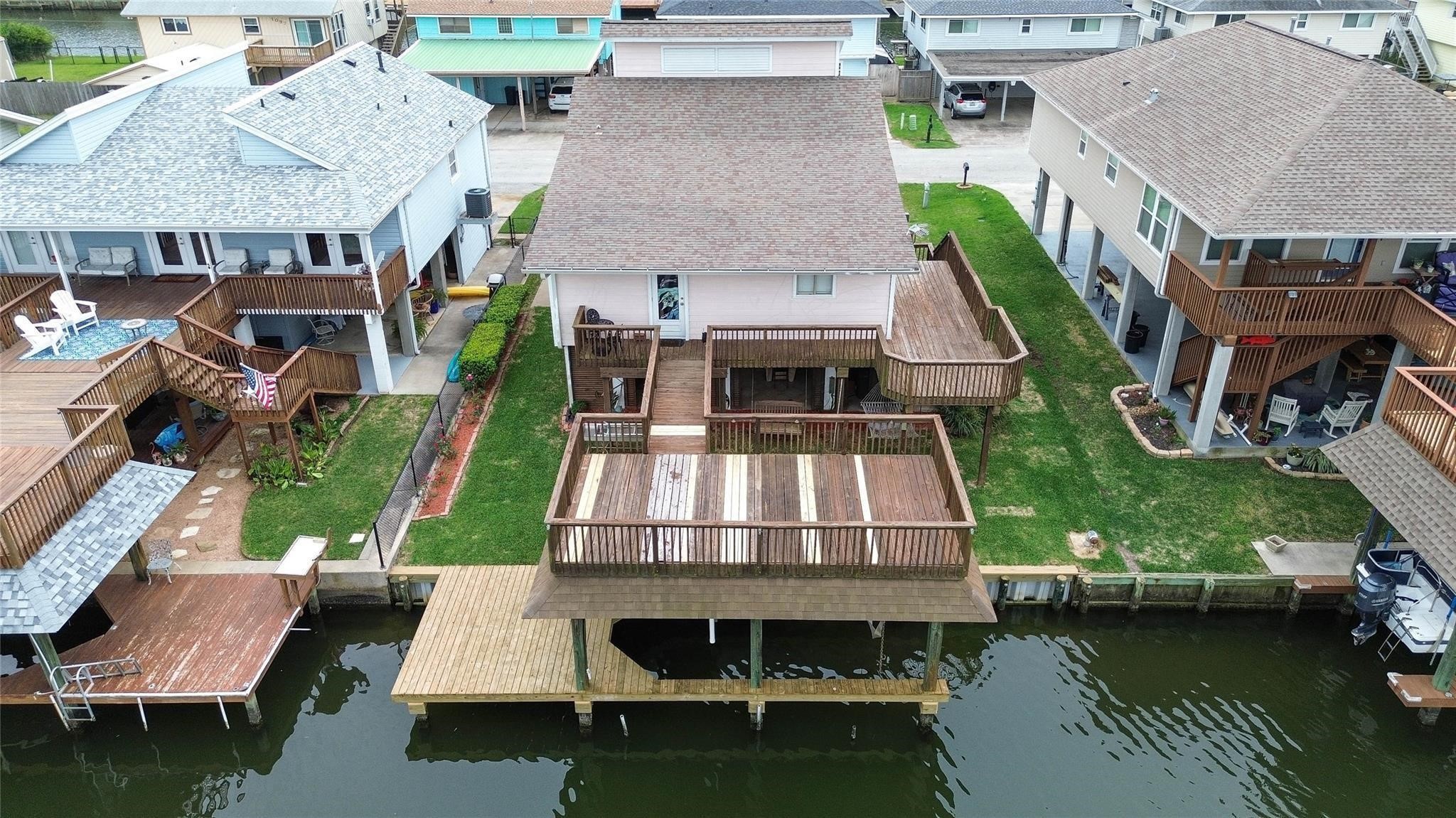 Waterfront home with multi-level wooden decks and a private dock, offering direct canal access. Ideal for boating enthusiasts and outdoor relaxation.