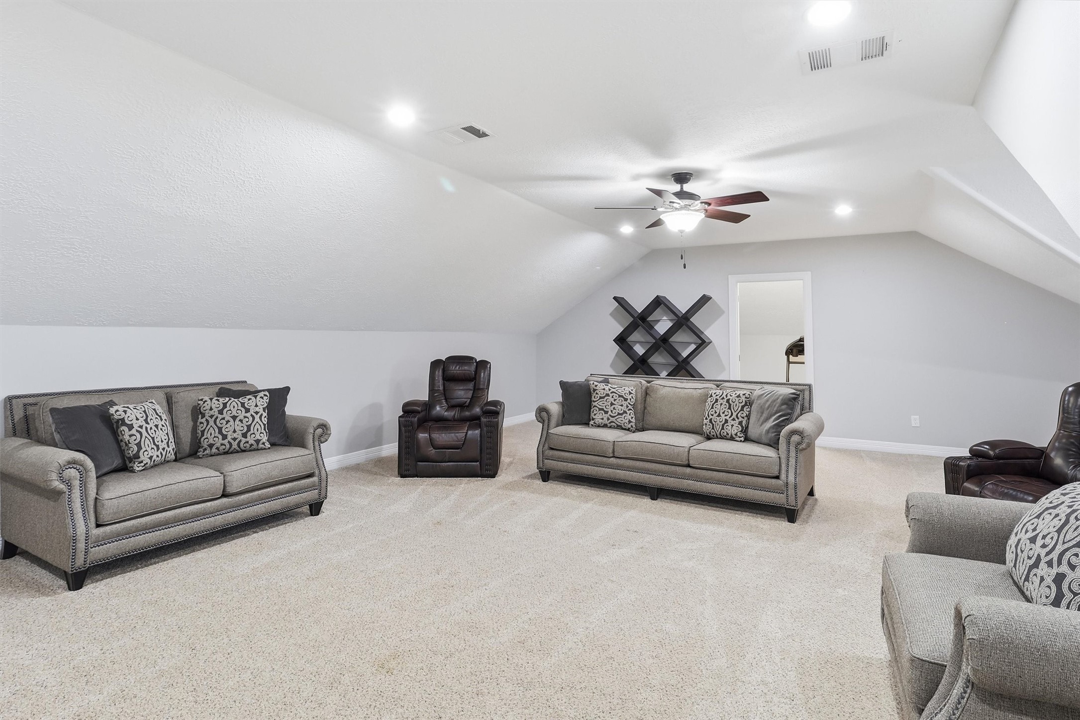 This expansive upstairs flex space offers vaulted ceilings and plenty of room for a media area, playroom, or additional living space, adapting easily to your lifestyle.