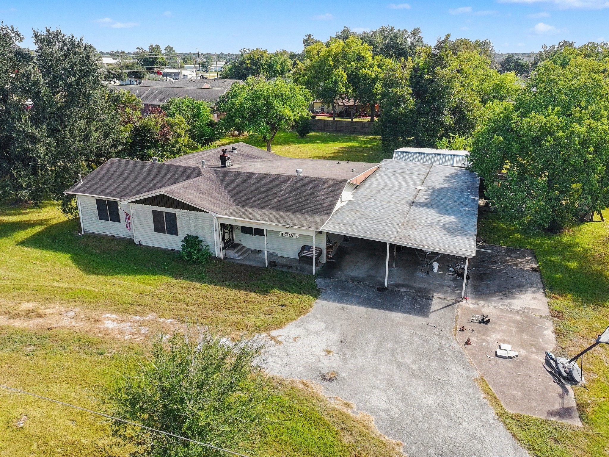 Fixer-Upper on approximately 1.07 acres with mature trees, covered parking, and plenty of potential