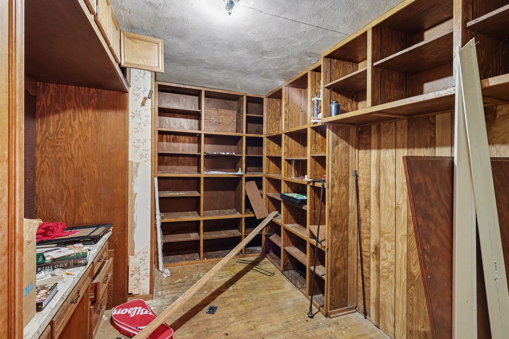 Home office with extensive built-in shelving and wood paneling