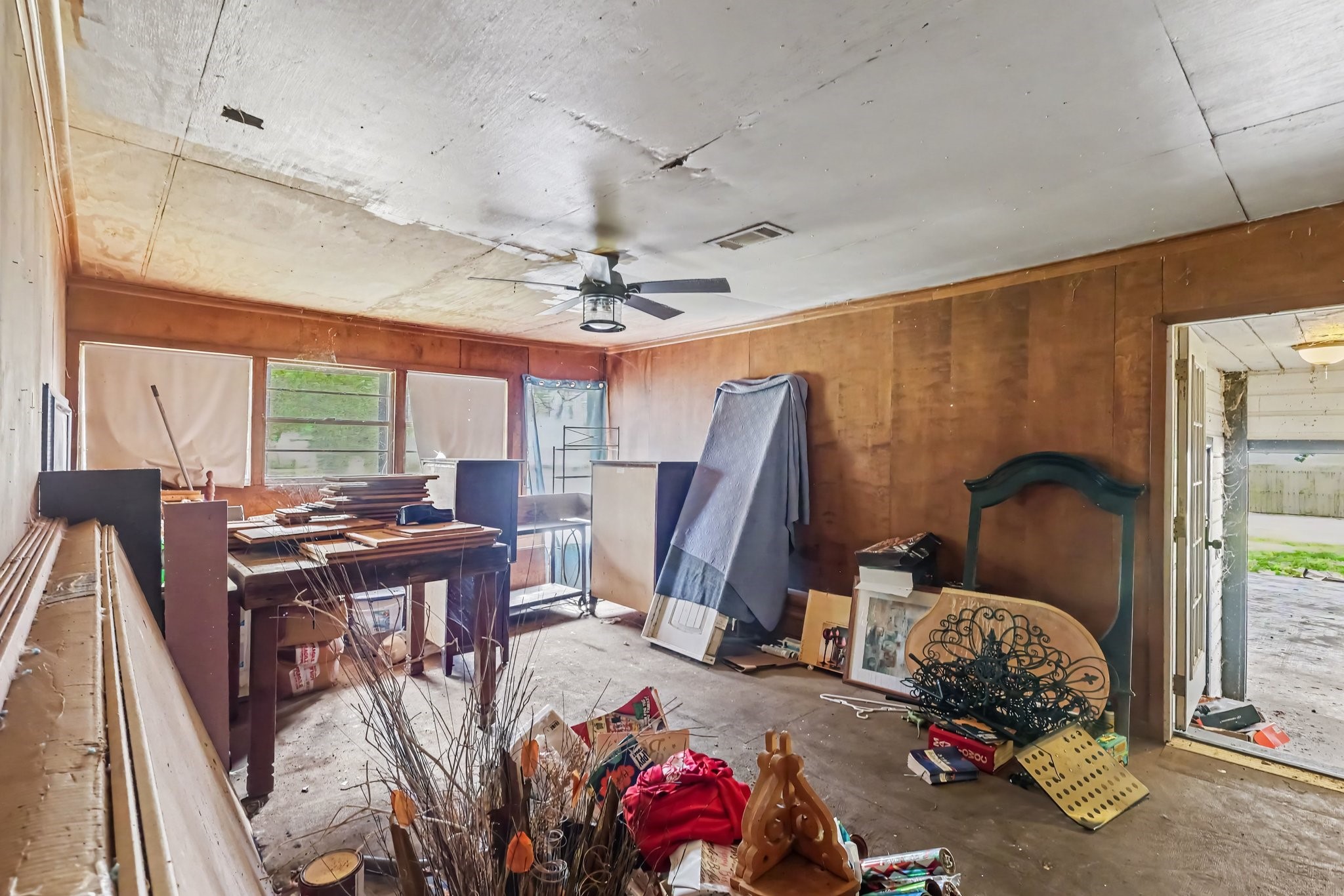 Family Room with wood paneling and outdoor access.